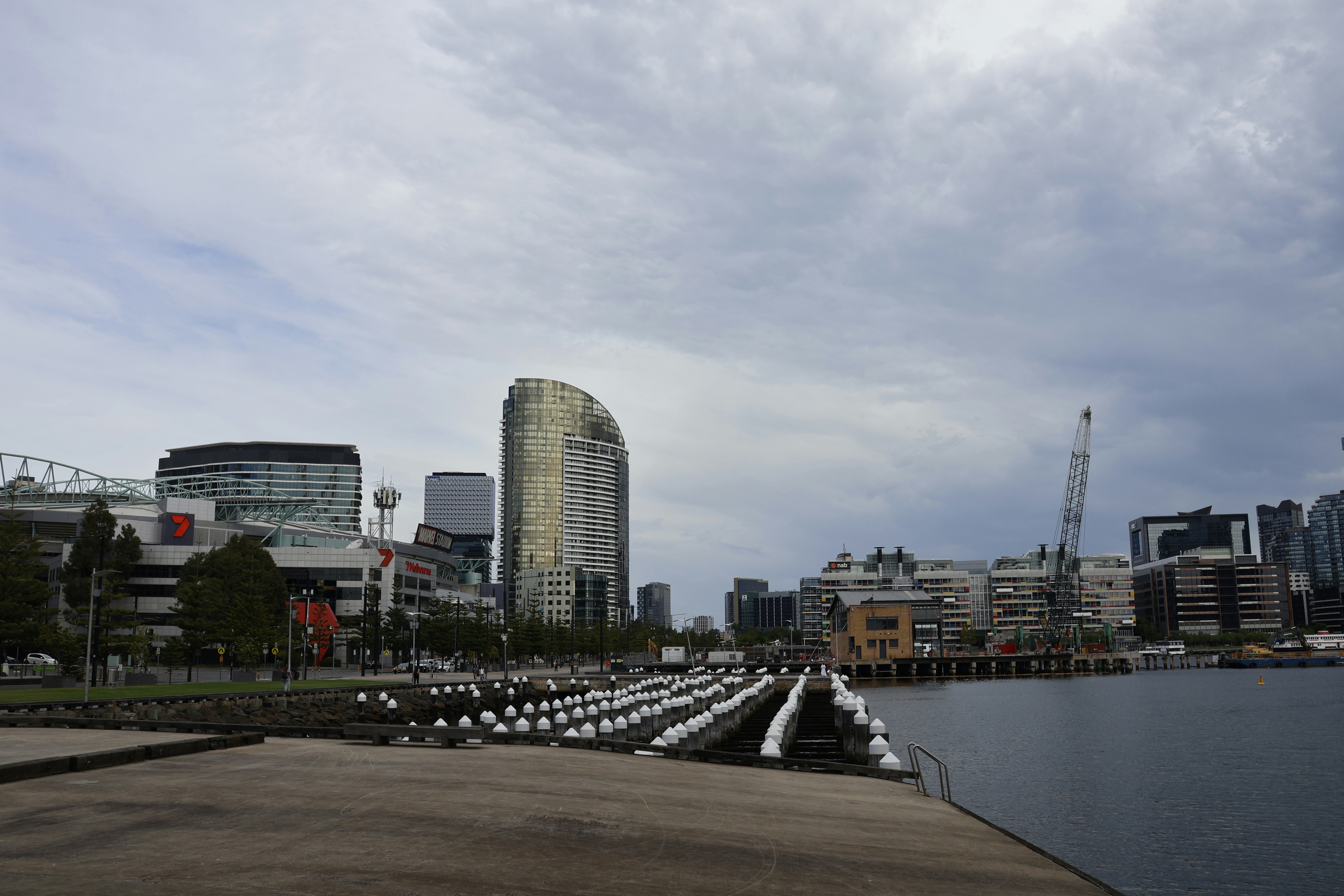 City skyline with modern buildings and a harbor.