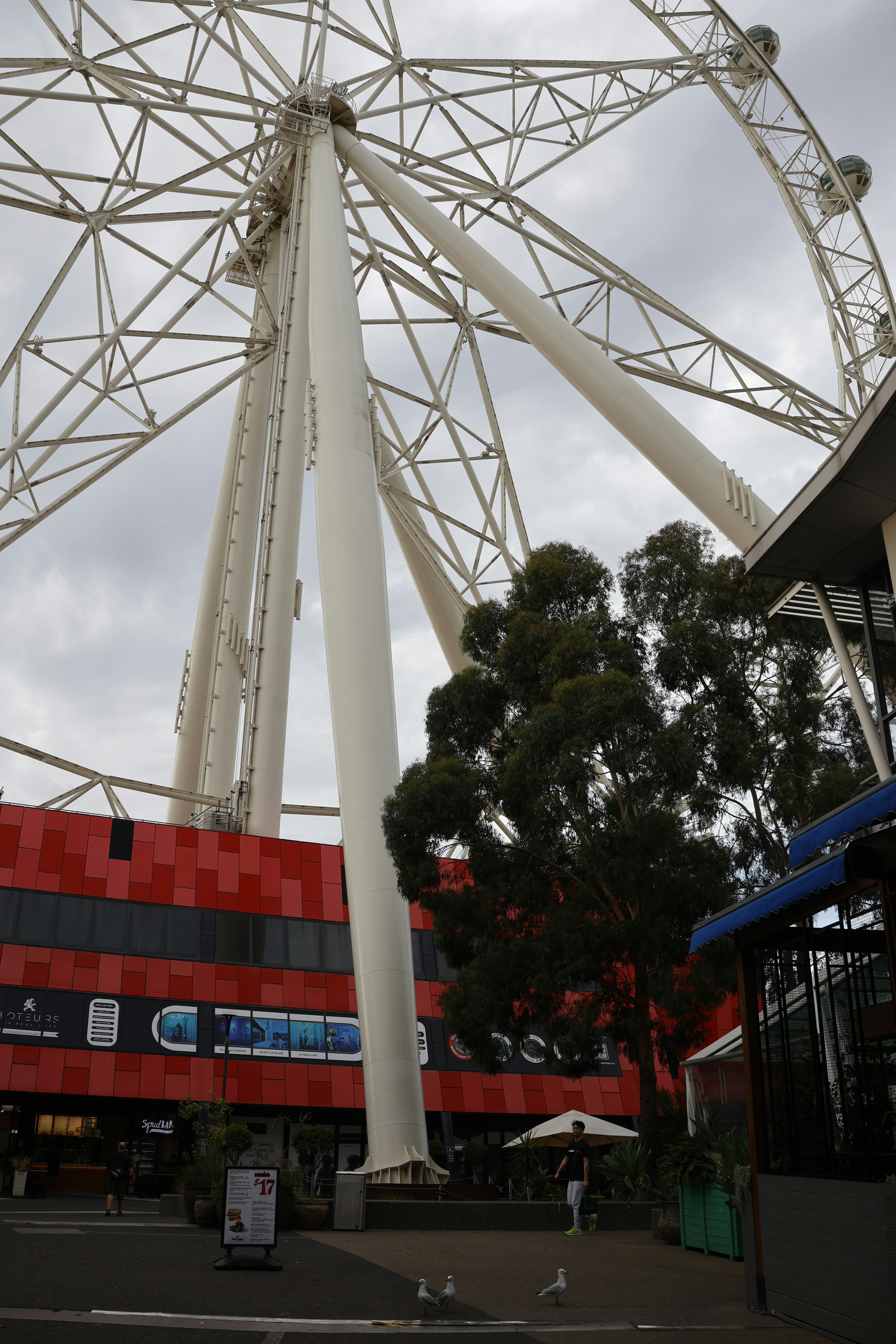Giant ferris wheel structure against a cloudy sky