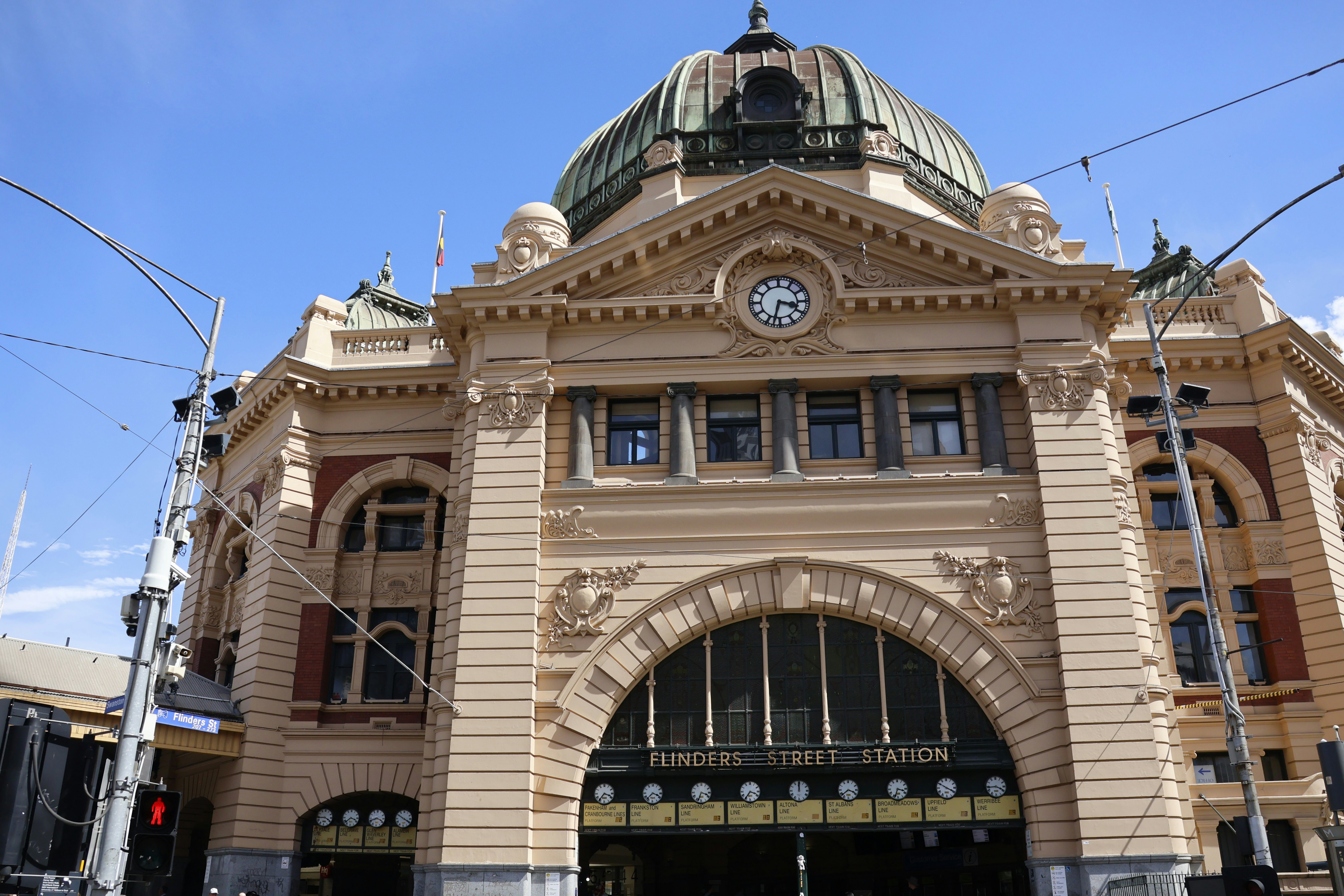 Grand building with a dome and large arched entrance.
