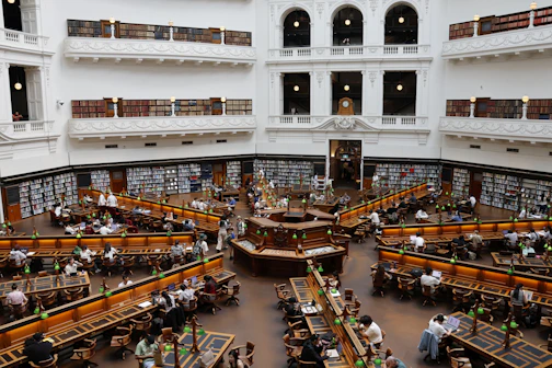 Grand library interior with many people reading