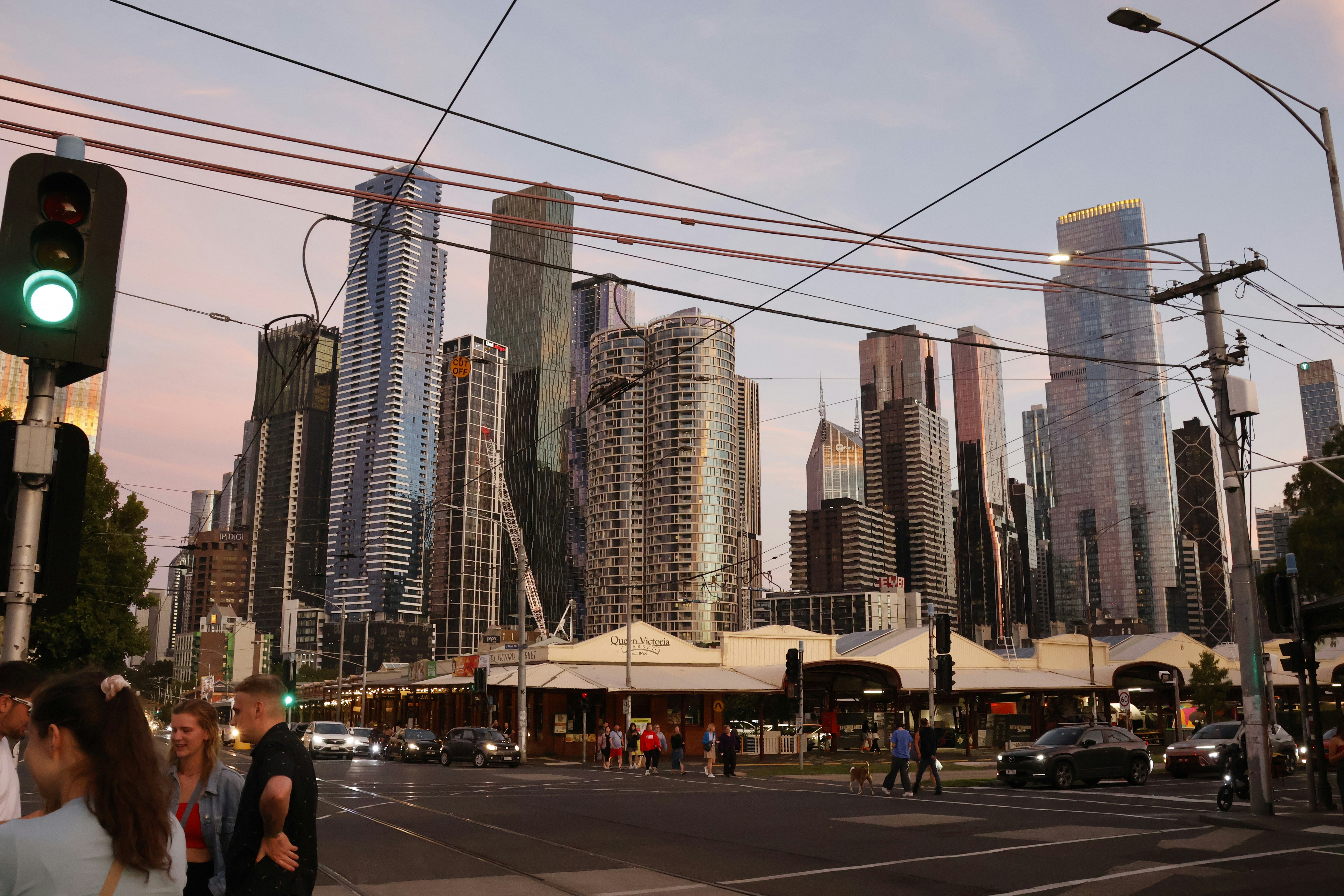 Modern cityscape with tall buildings and traffic lights.
