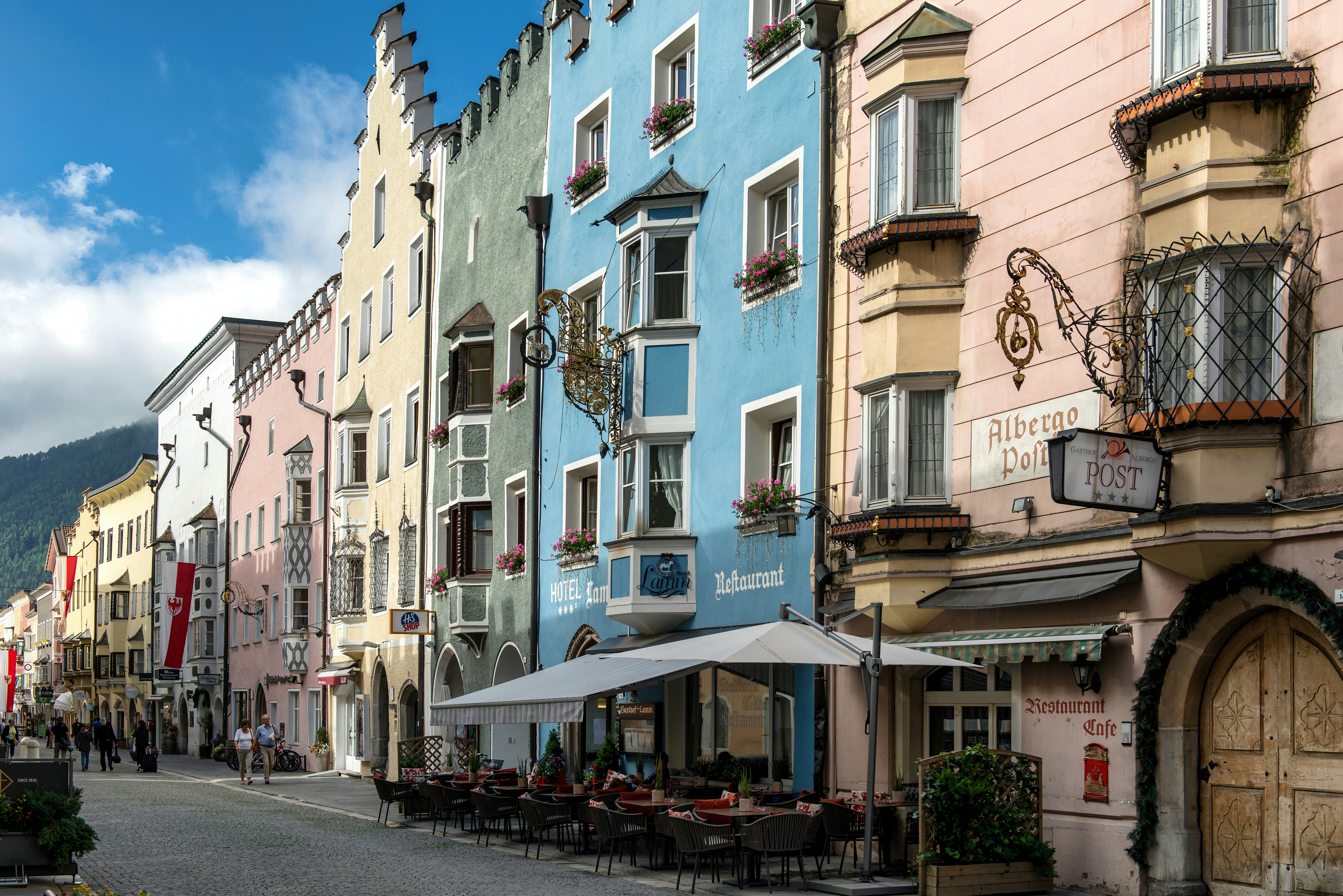 Colorful historic buildings line a european street.