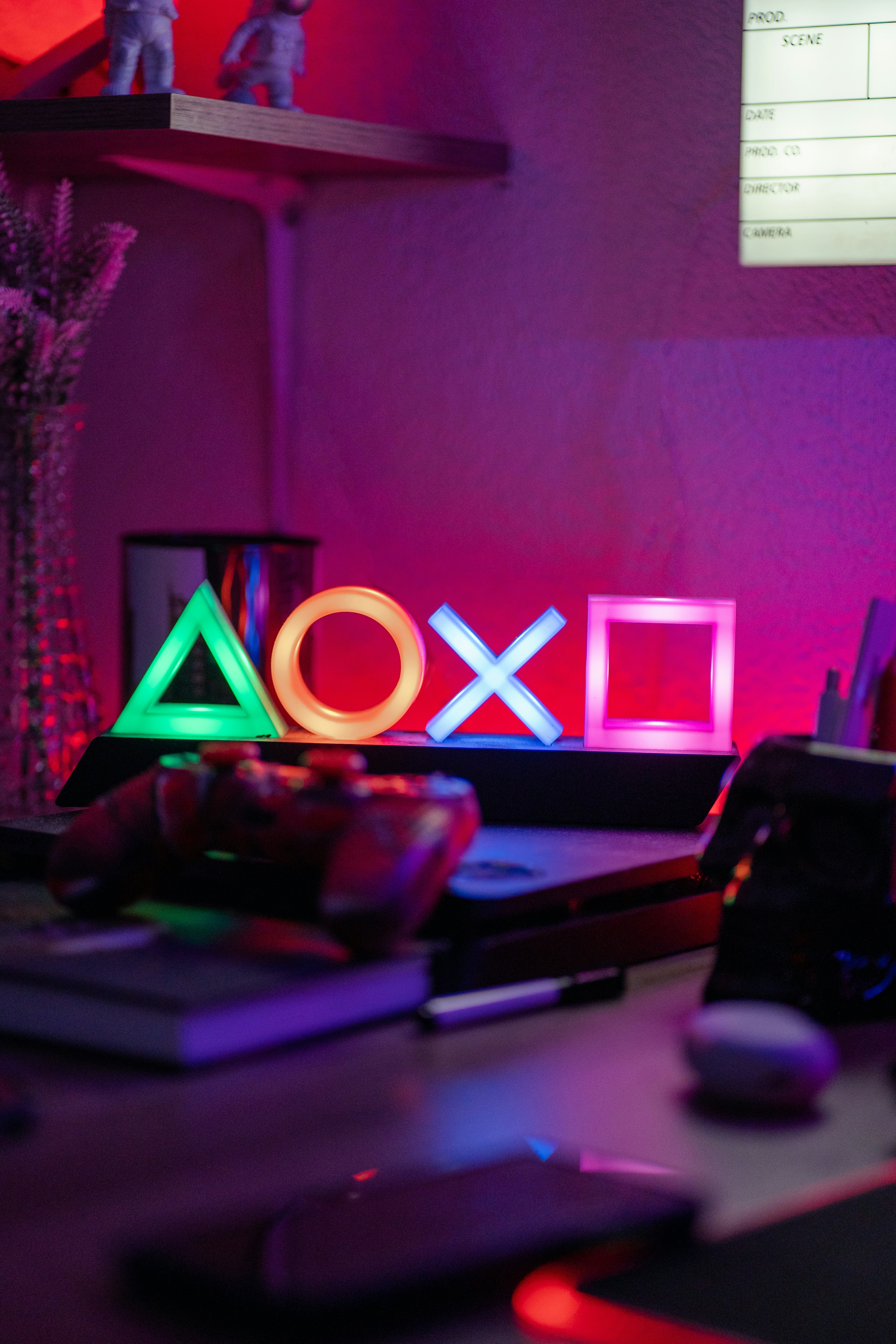 Playstation symbols illuminated in neon light