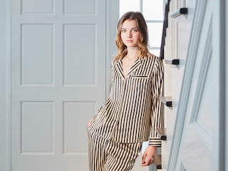 Young woman wearing striped pajamas indoors