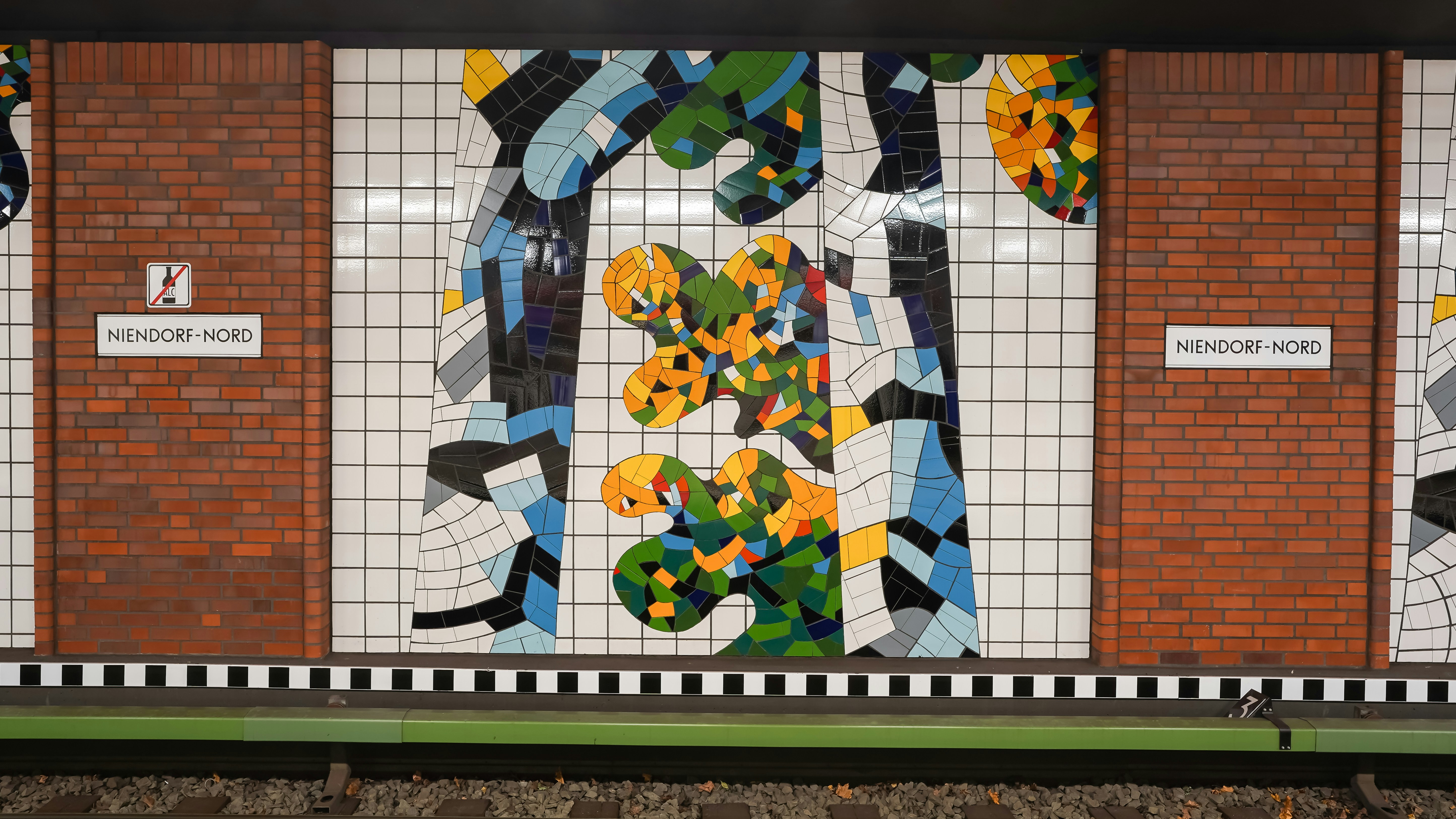 Colorful mosaic art on subway station wall