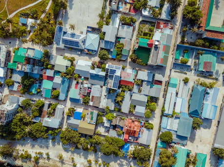 Aerial view of a tropical island village with colorful roofs.