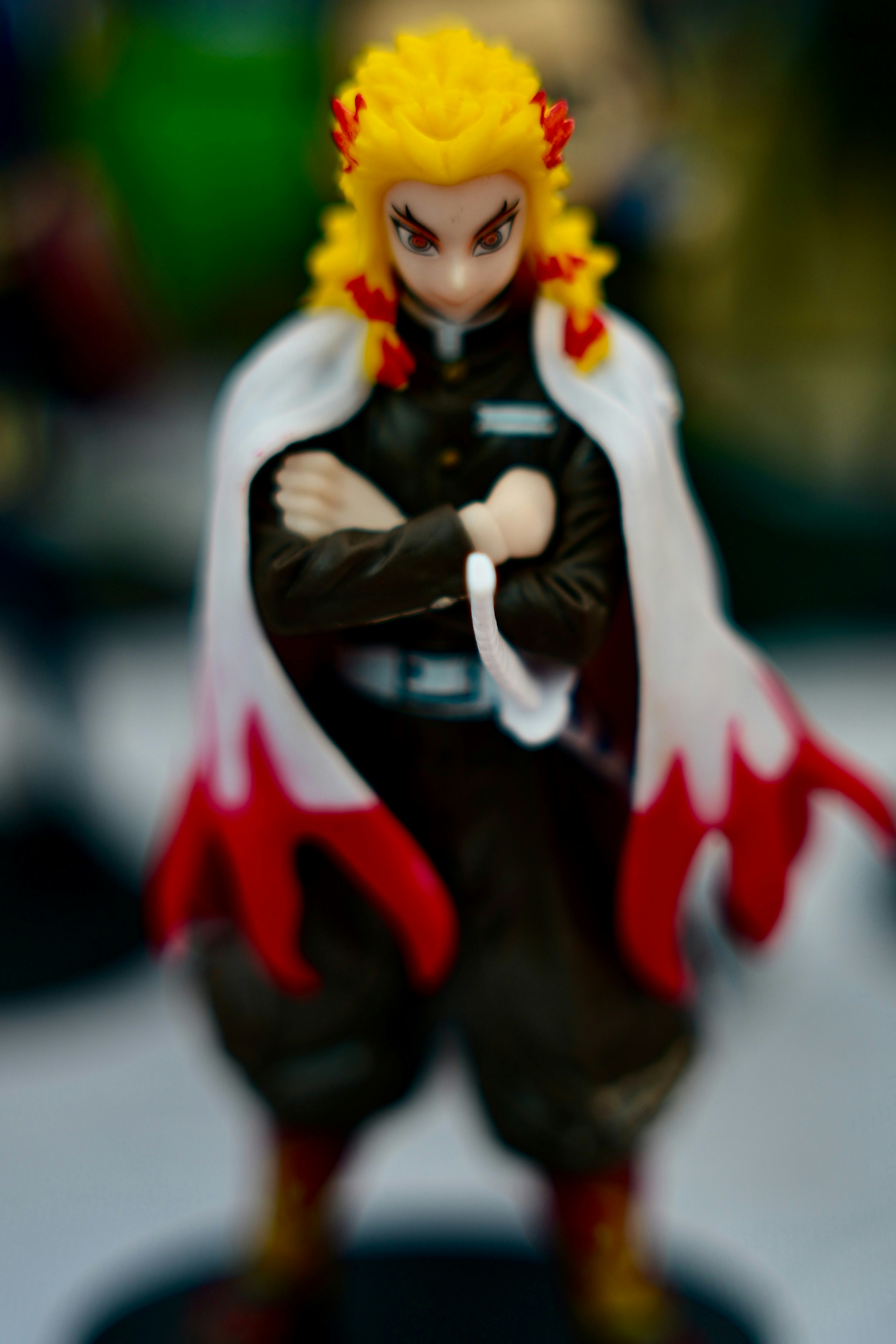 Anime character with fiery hair and cape.