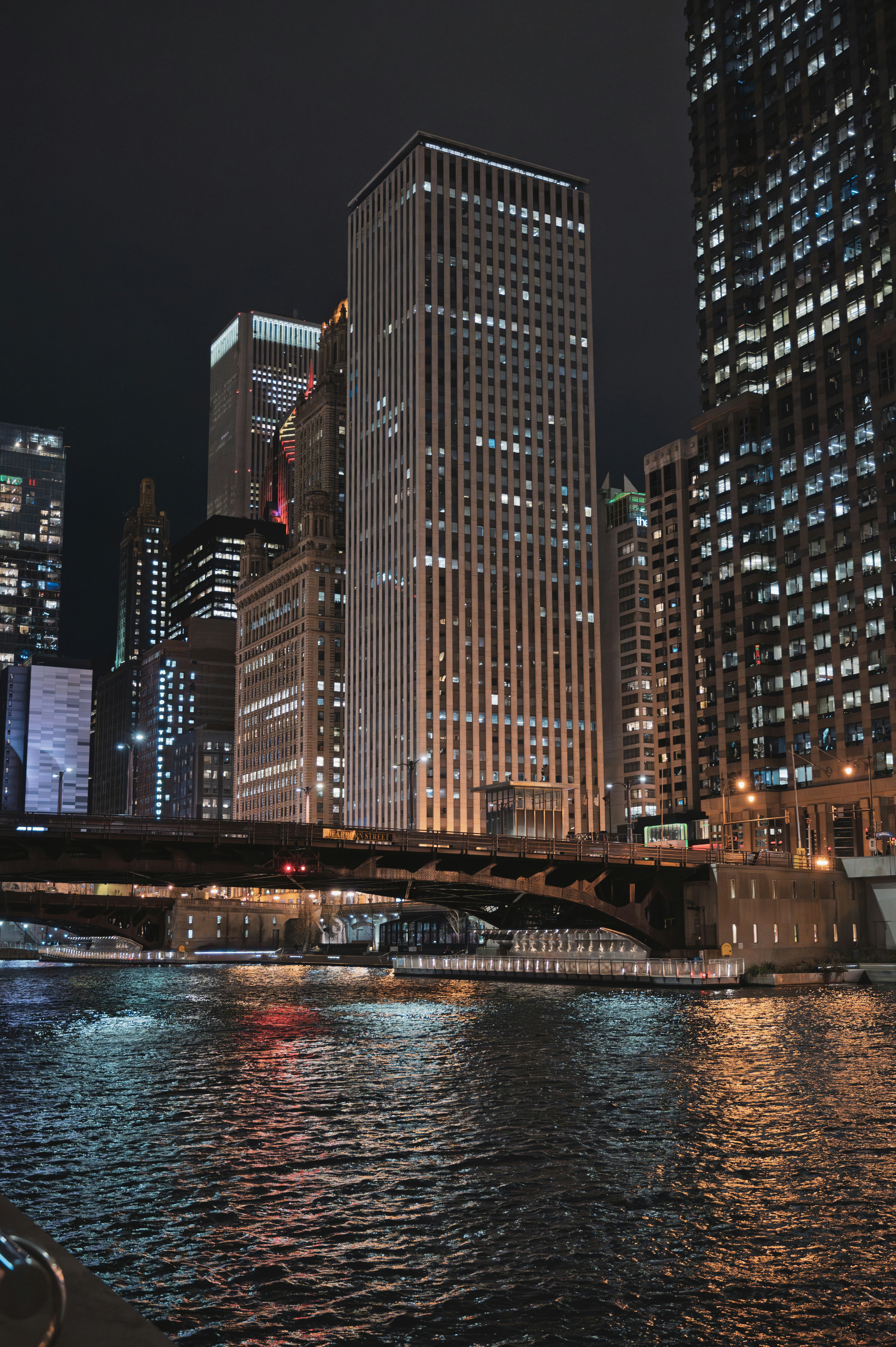 Cityscape with illuminated skyscrapers and river at night