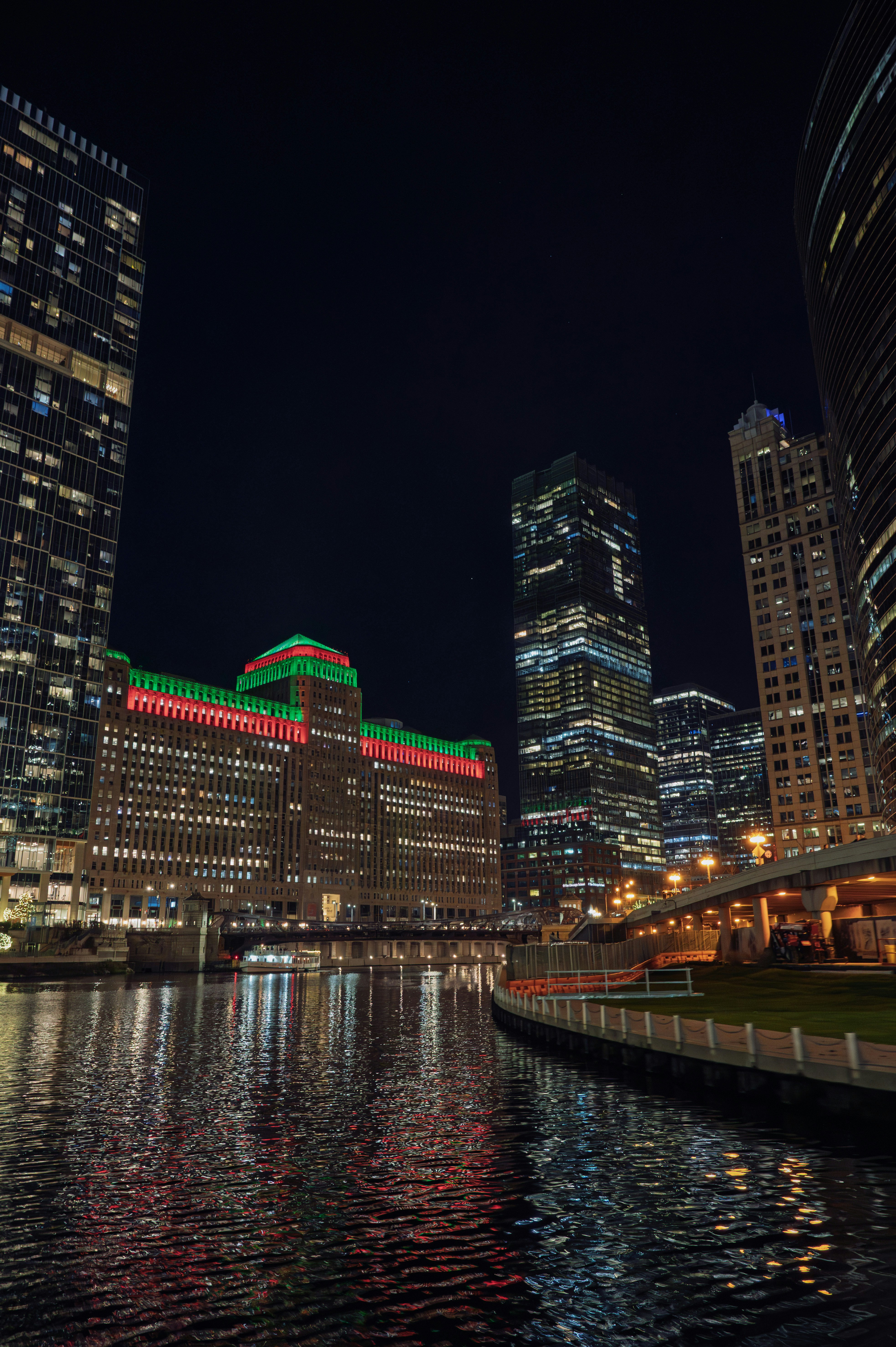 Cityscape with illuminated buildings and river at night