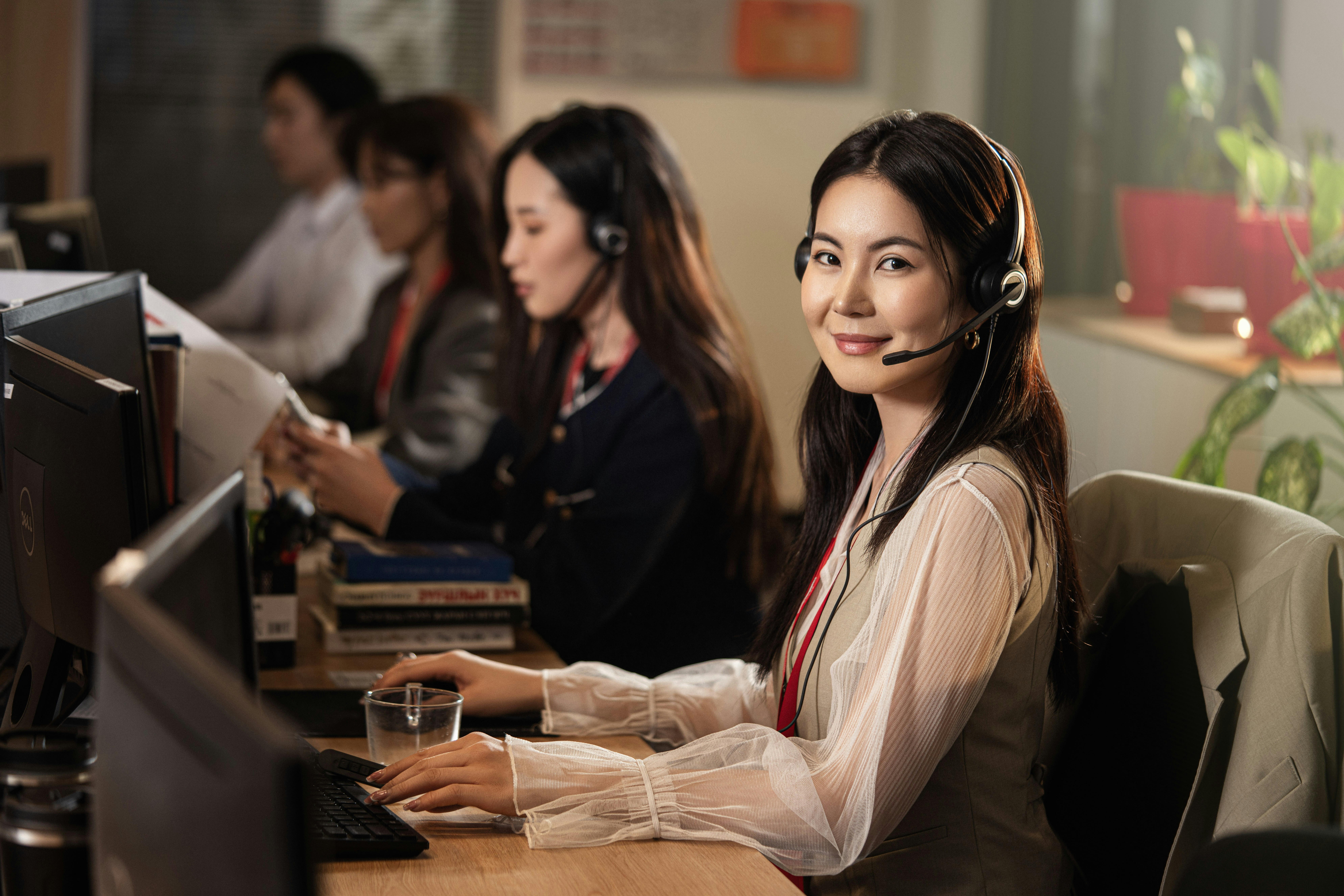 Professionals working together in a modern office, highlighting teamwork, communication, and productivity. Young beautiful operator girl