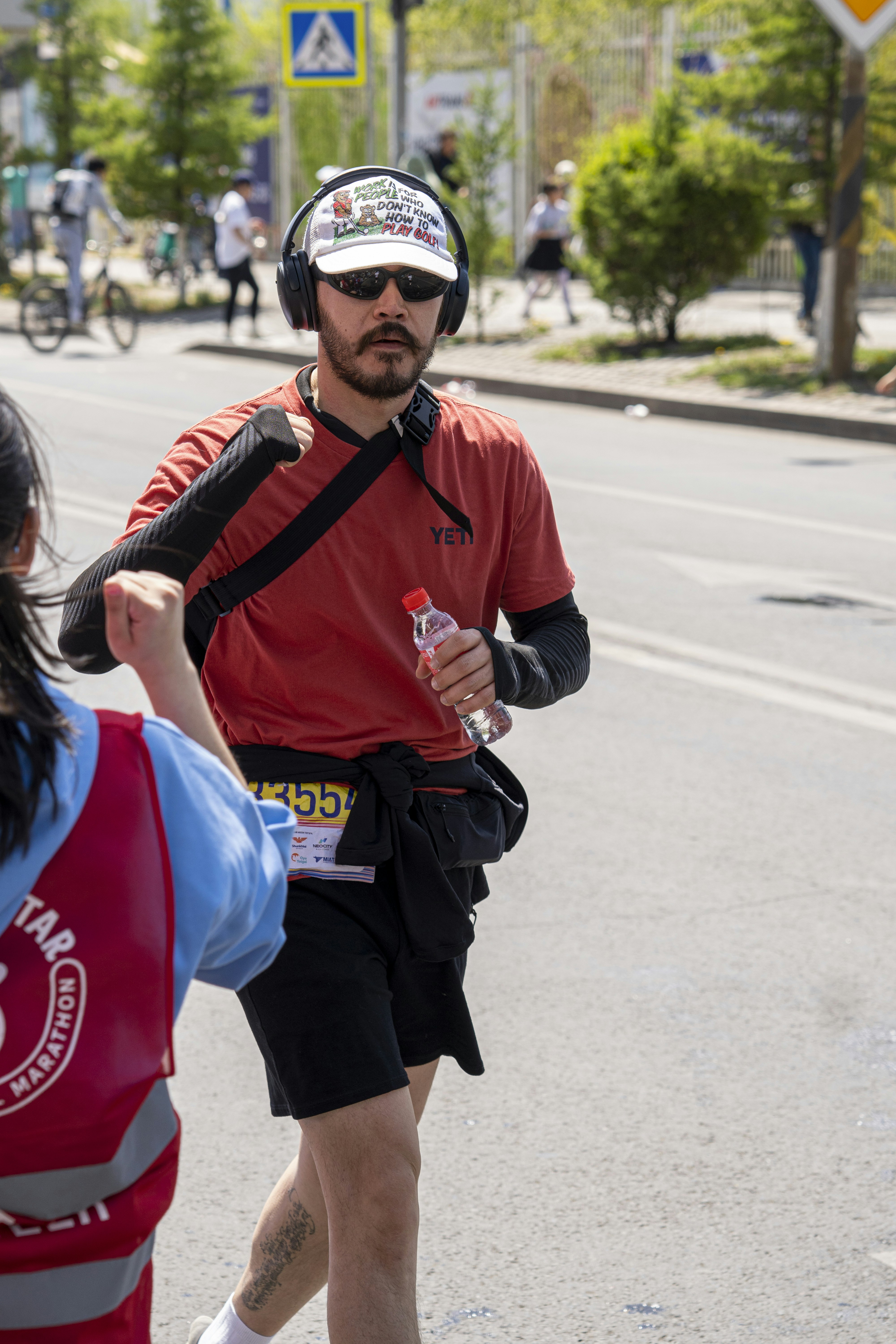 Runner wearing headphones receives high five during race