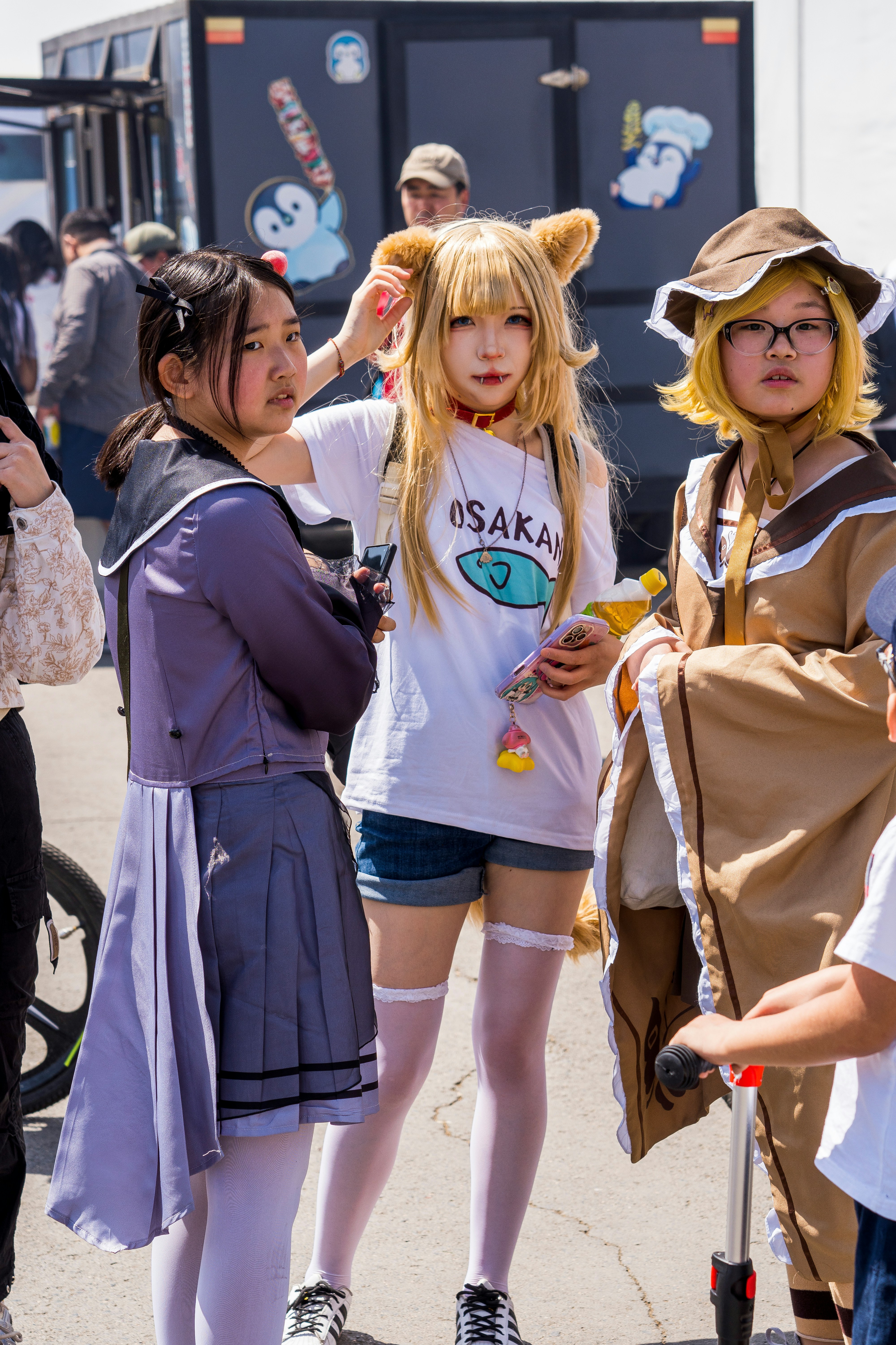 Cosplayers dressed as anime characters at an outdoor event.