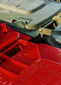 Red and green plastic bins stacked together.