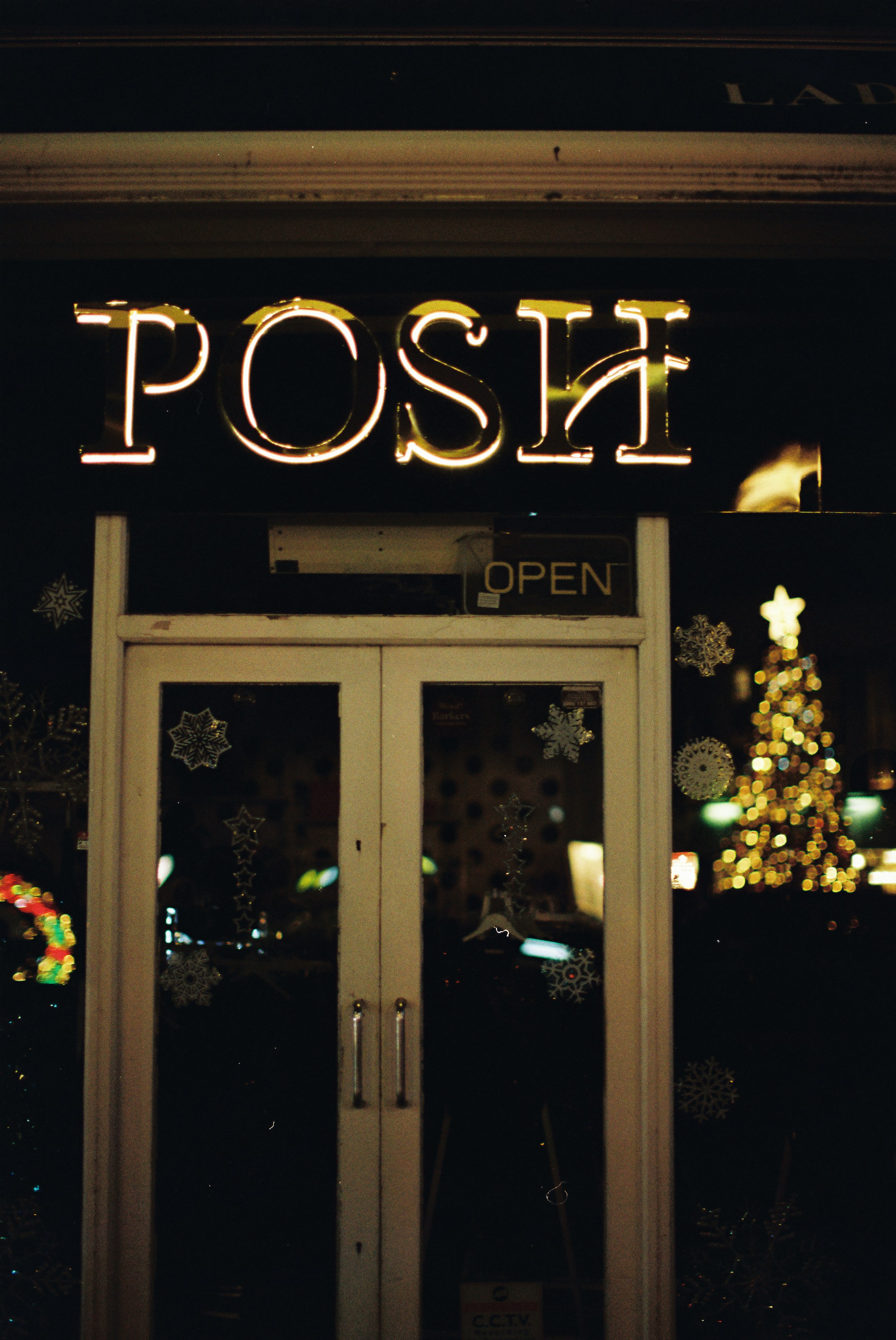 Neon sign posh above a closed shop door photo – Free Night Image on ...