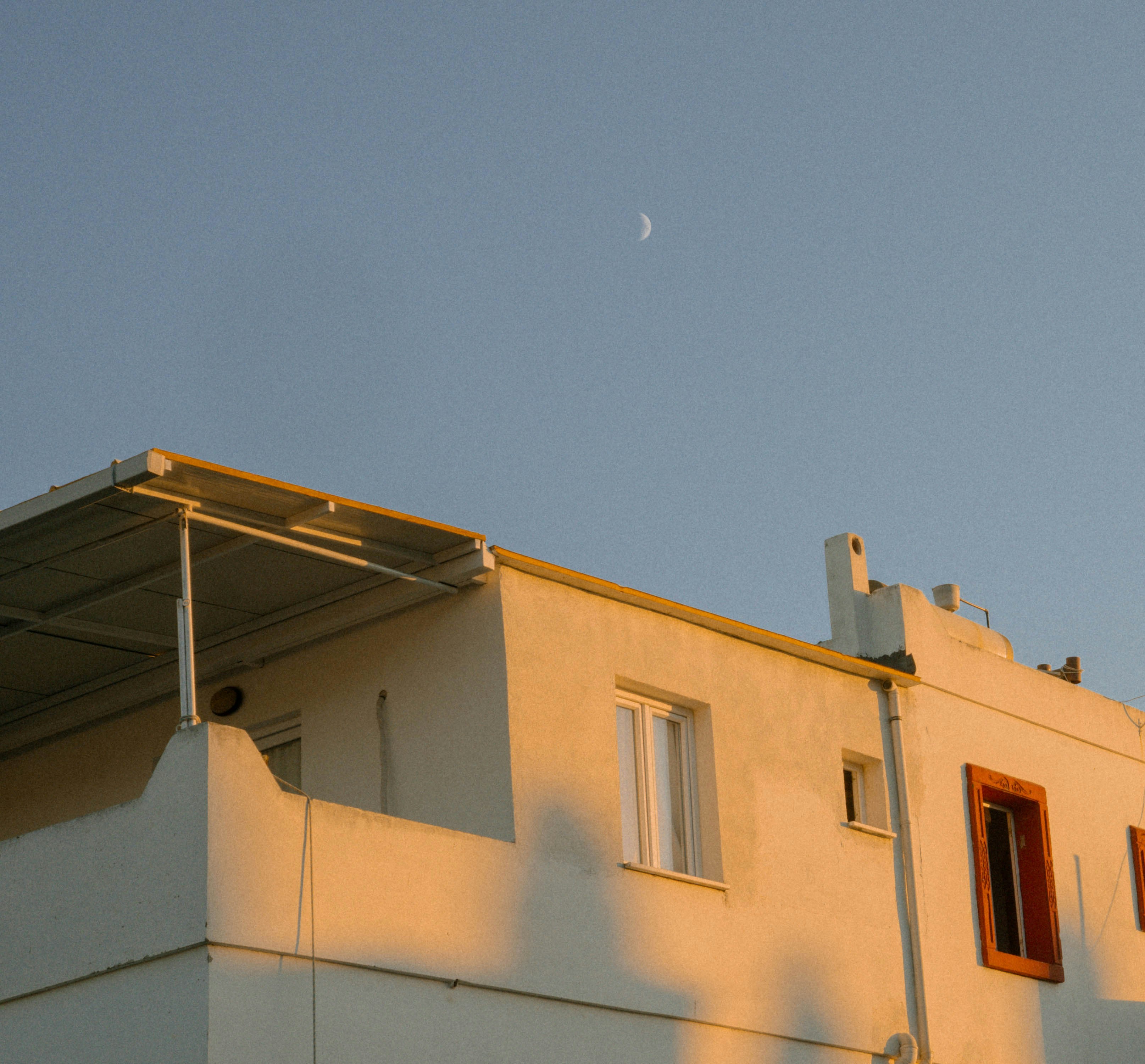 White building with balcony in golden hour light