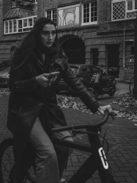 Woman riding a bicycle on a city street.