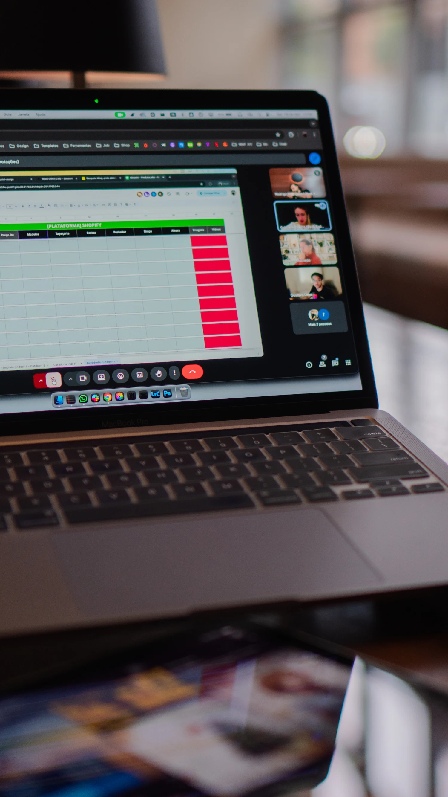 Laptop screen showing a video conference and spreadsheet
