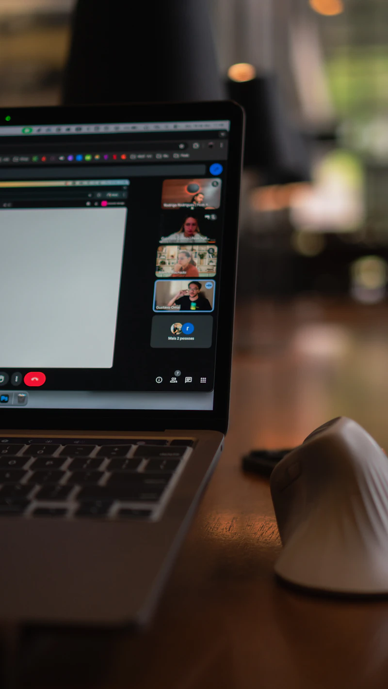 Laptop screen showing a remote team video conference