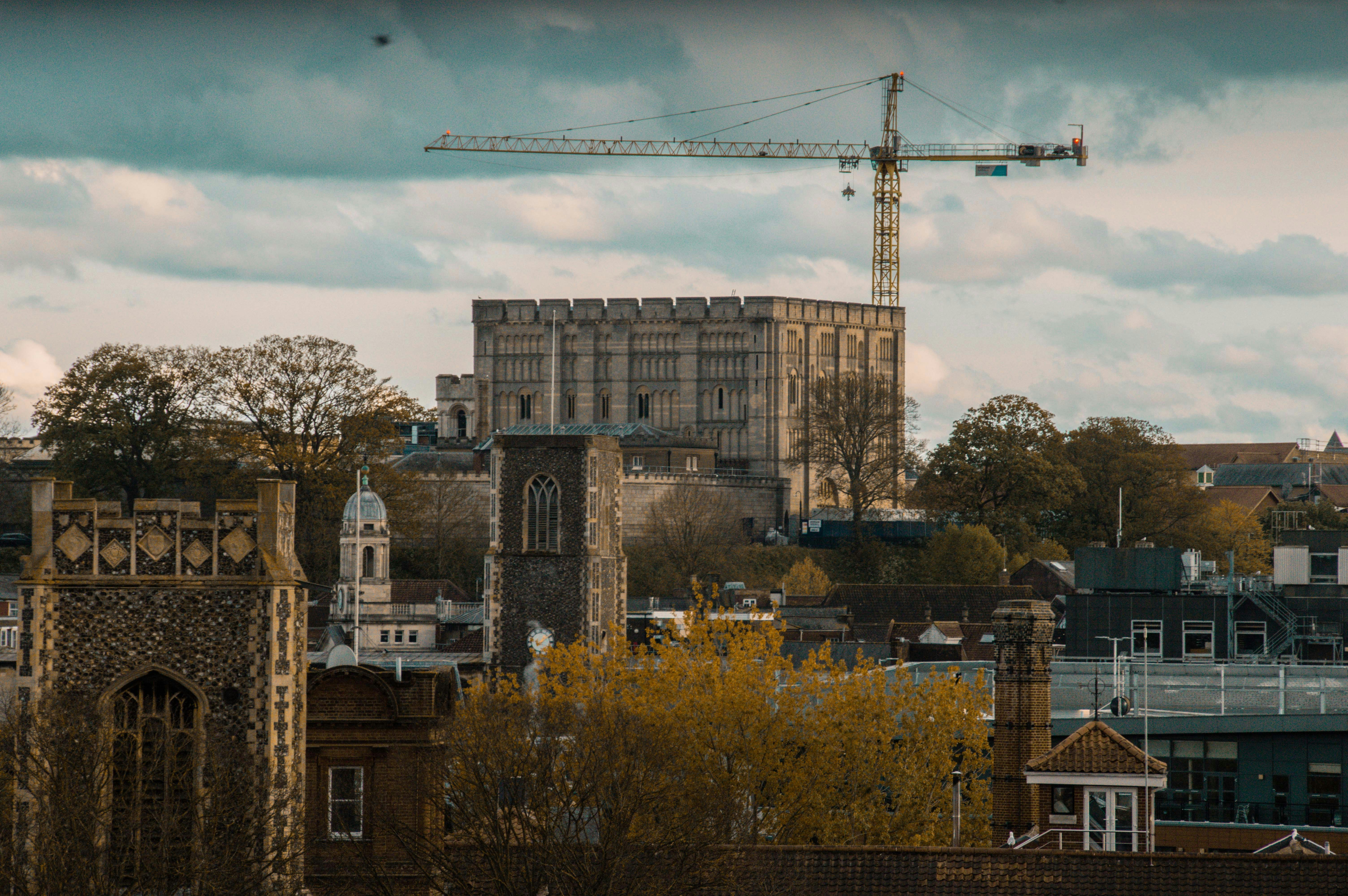 Historic buildings and construction crane under cloudy sky