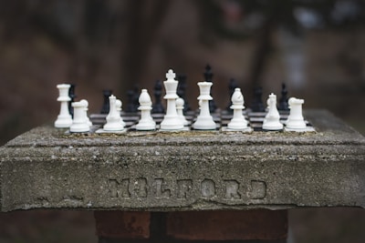 Chess pieces arranged on a stone surface