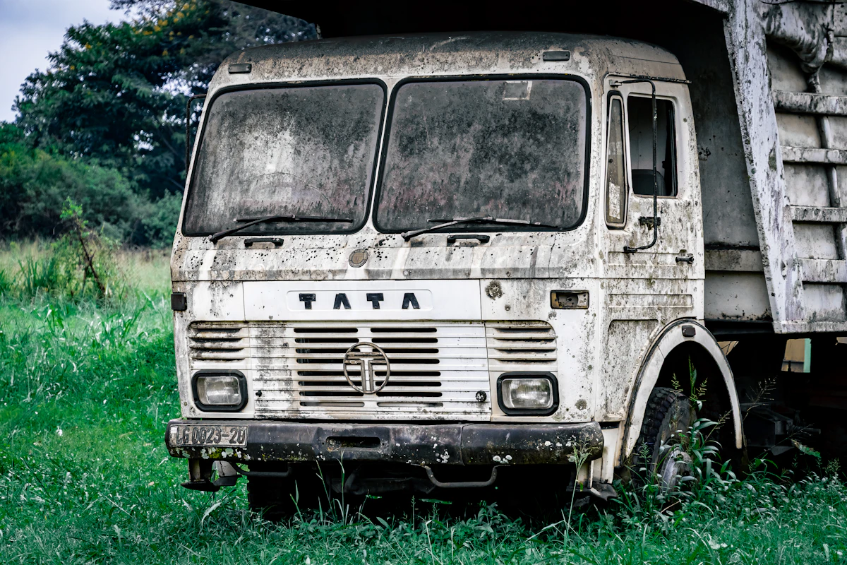 Front view of a white Tata goods truck parked on grass