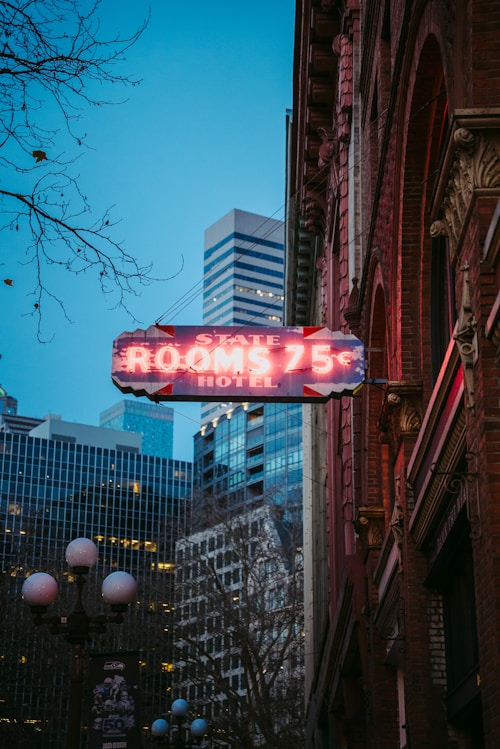 Neon sign for state rooms 75 hotel at dusk