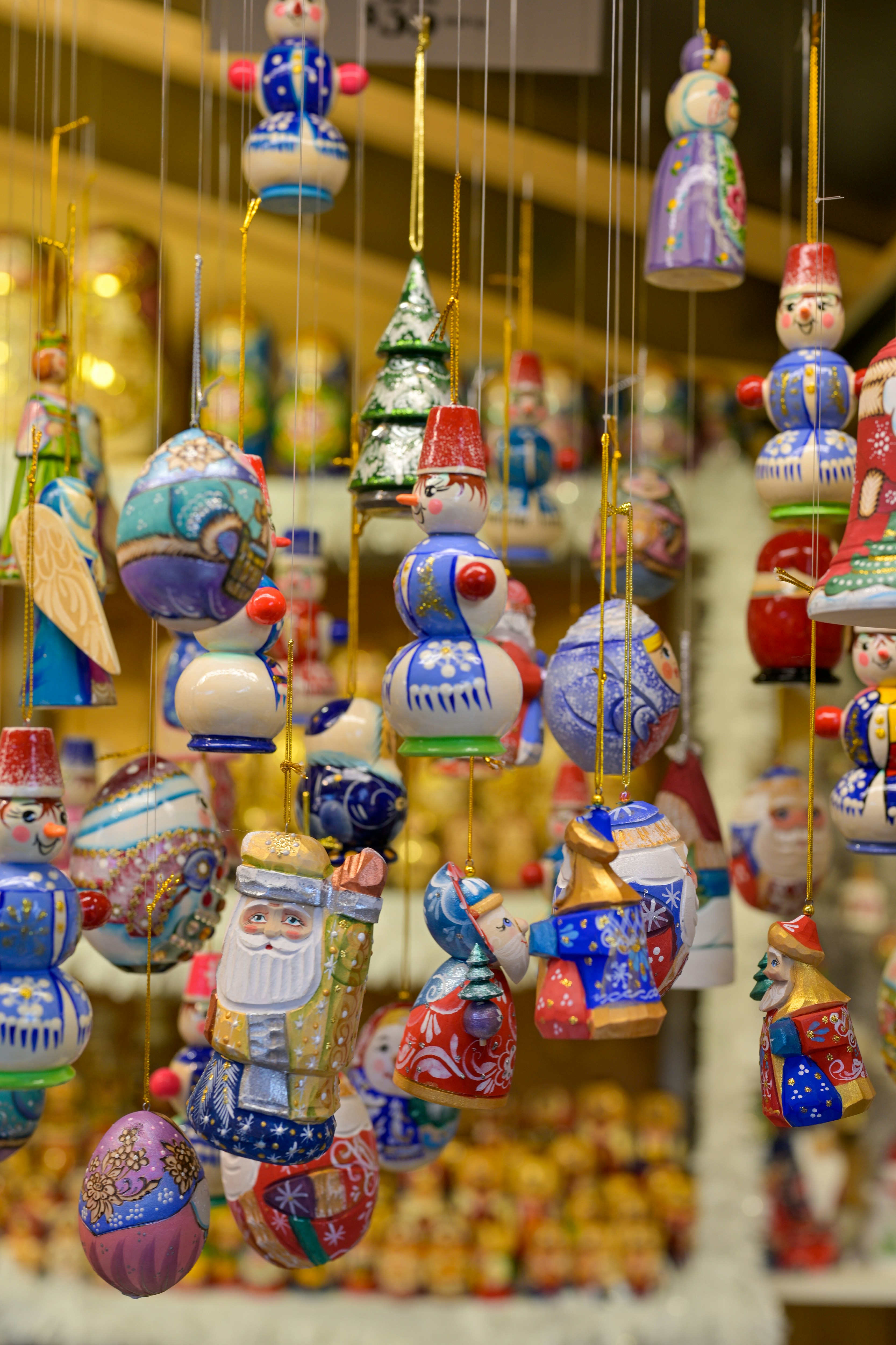 Colorful hanging christmas ornaments in a market.