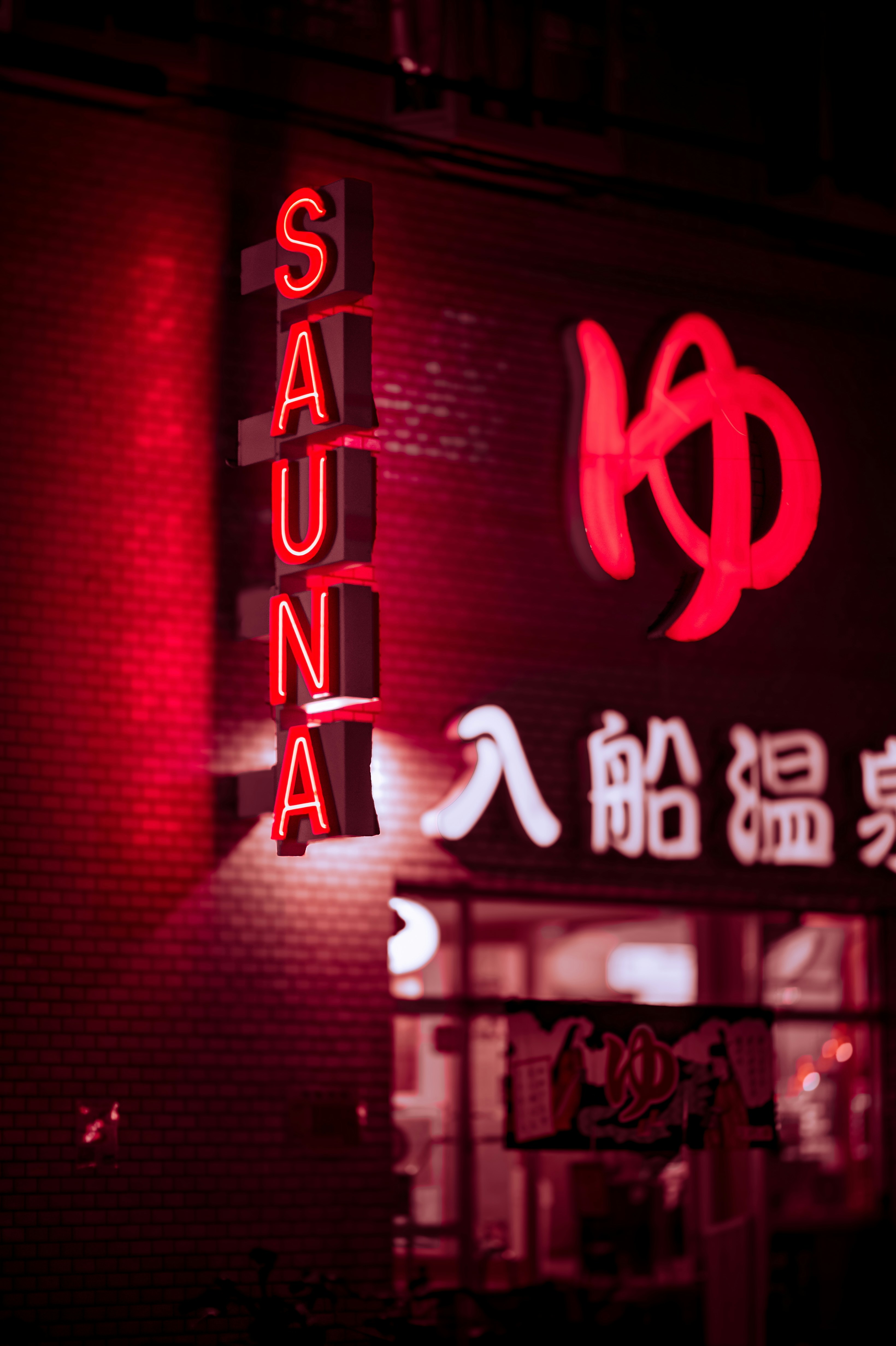 Red neon sign for a sauna at night
