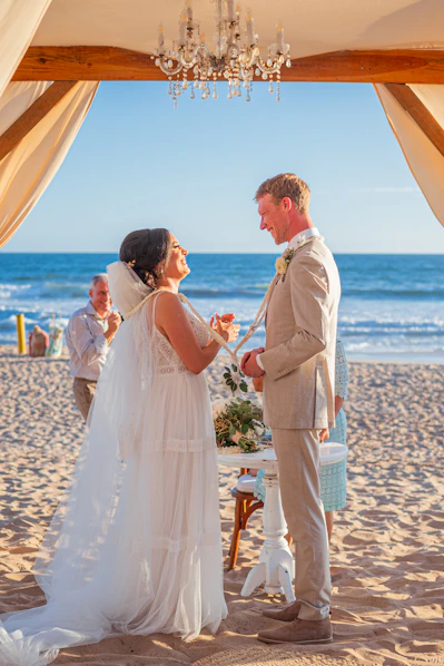 Couple exchanging vows during beach wedding ceremony