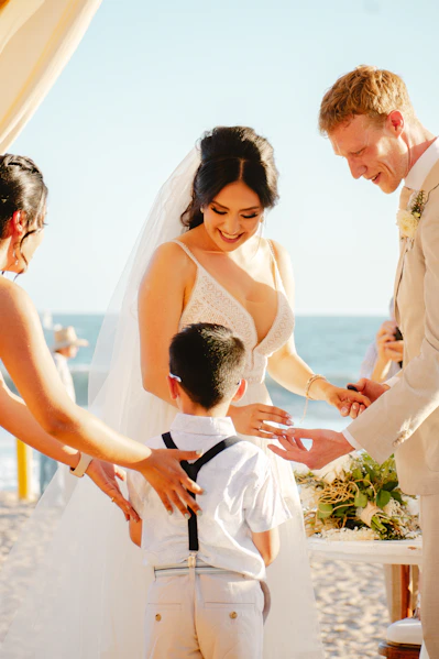 Bride and groom holding hands with a child