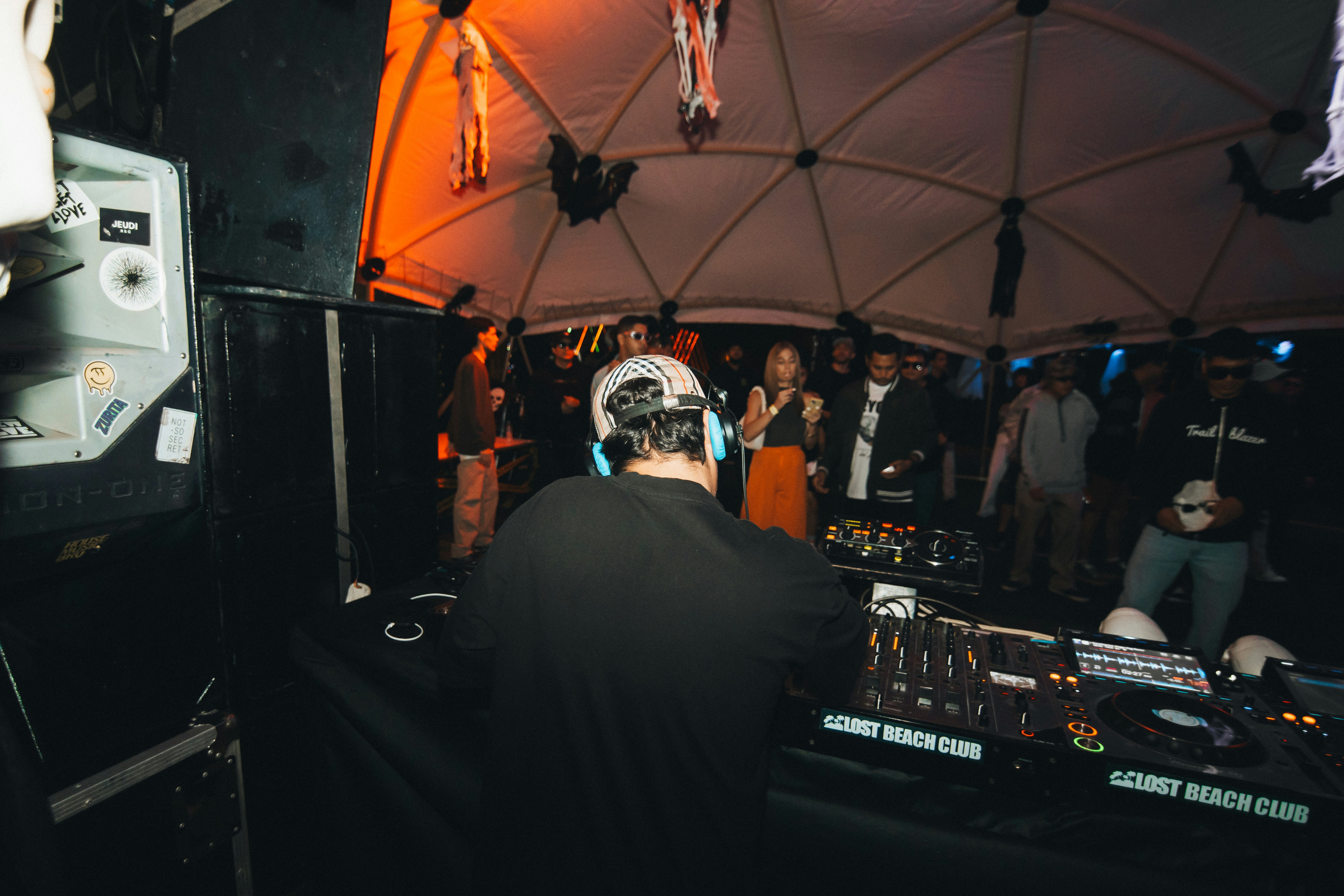 Dj performing for a crowd in a club