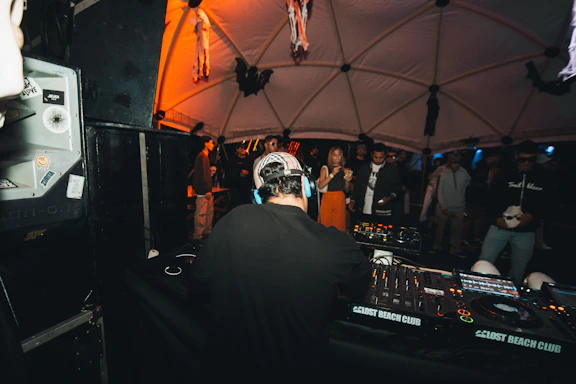 Dj performing for a crowd in a club