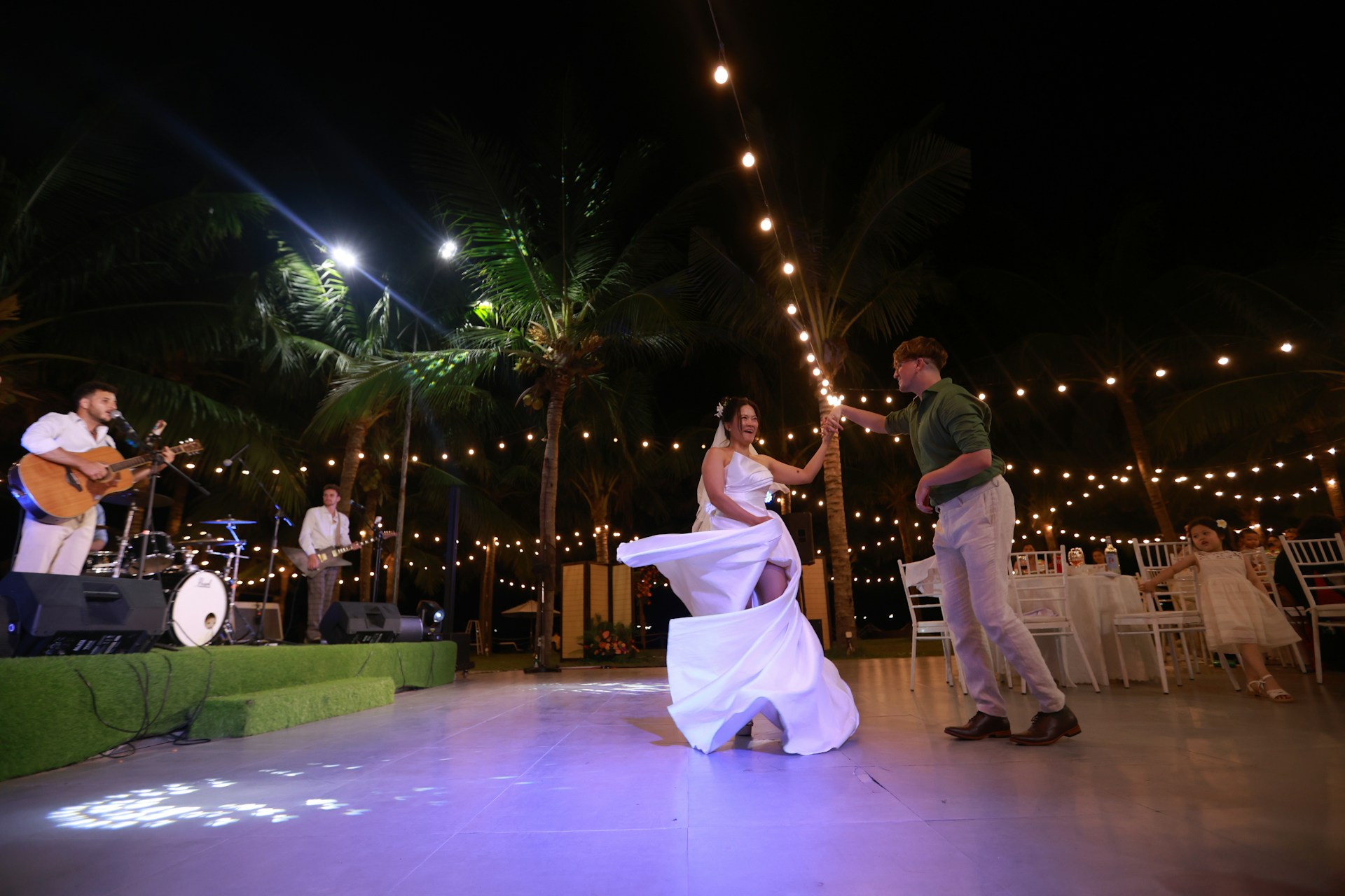 Couple dancing at a wedding reception with live band.