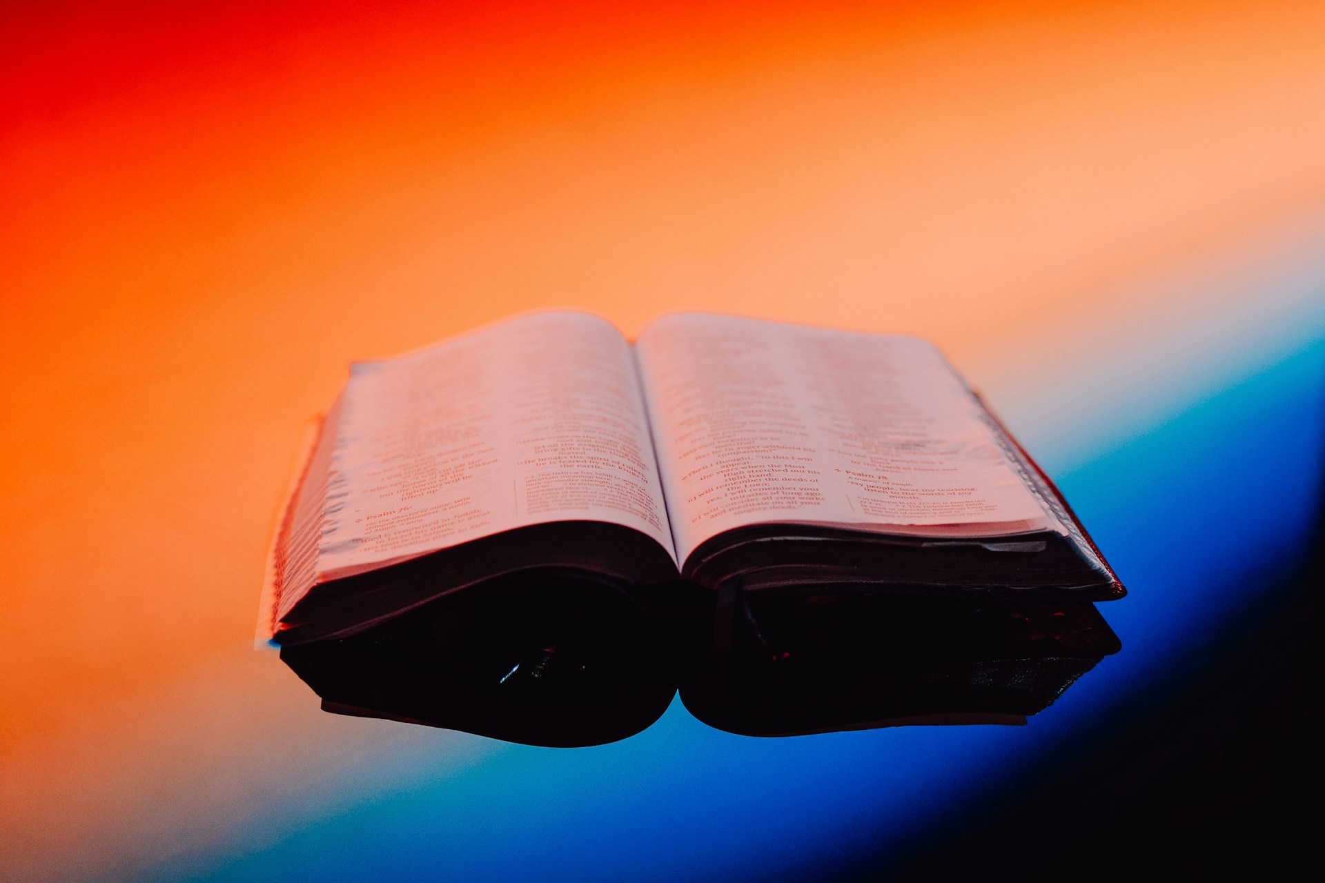 An open book on a reflective surface.