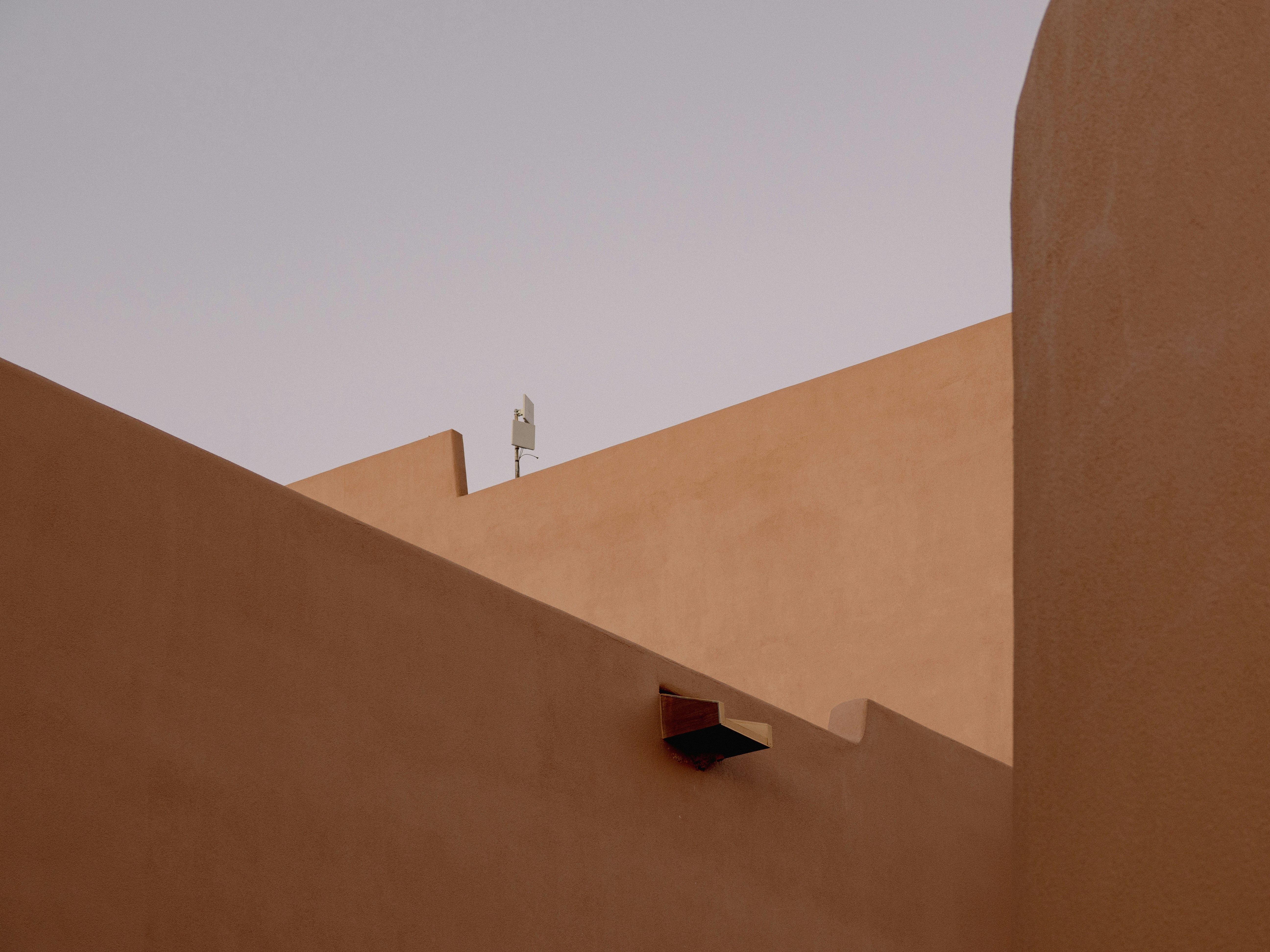 Geometric architecture with stepped walls and clear sky