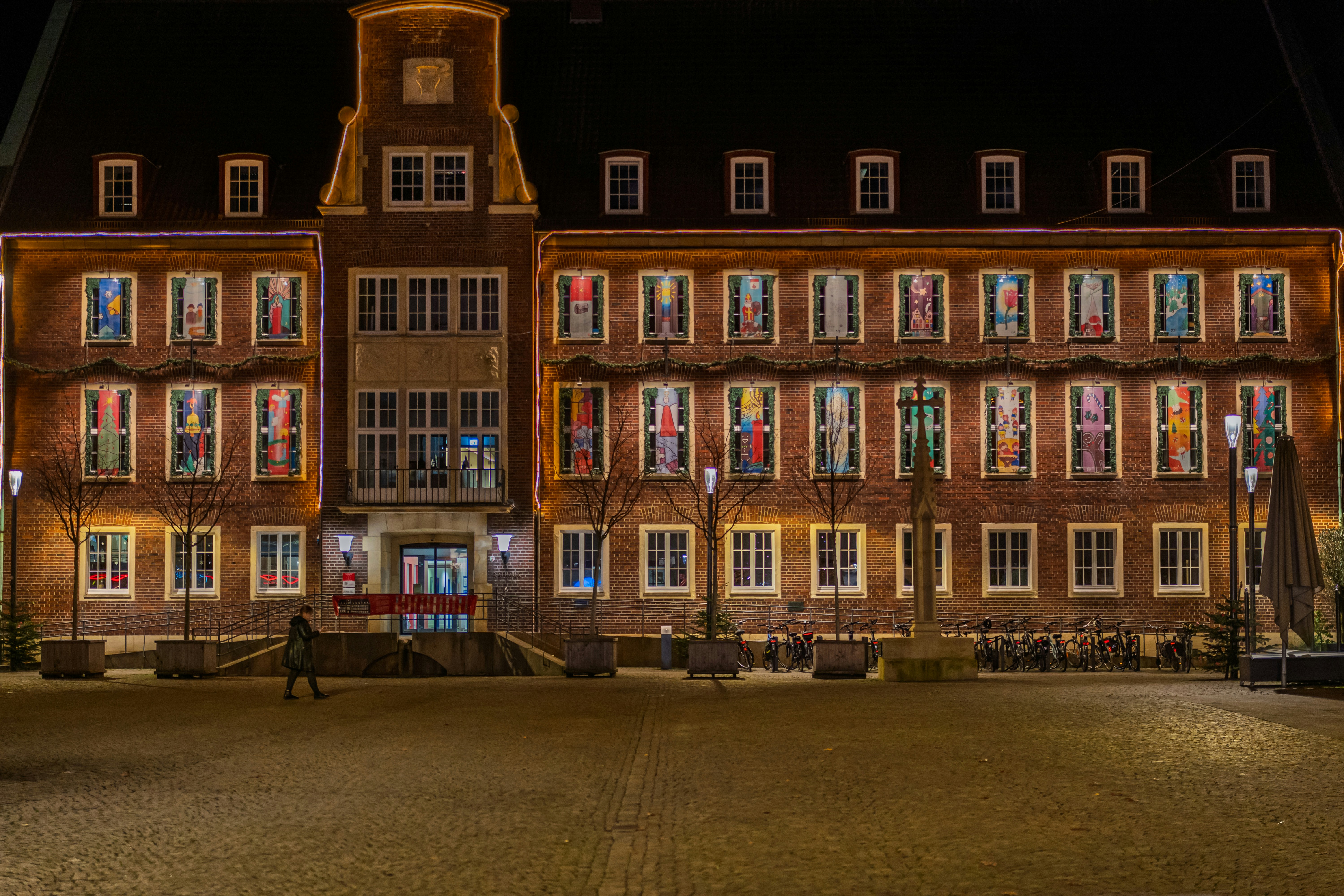 Historic building illuminated with colorful window lights at night