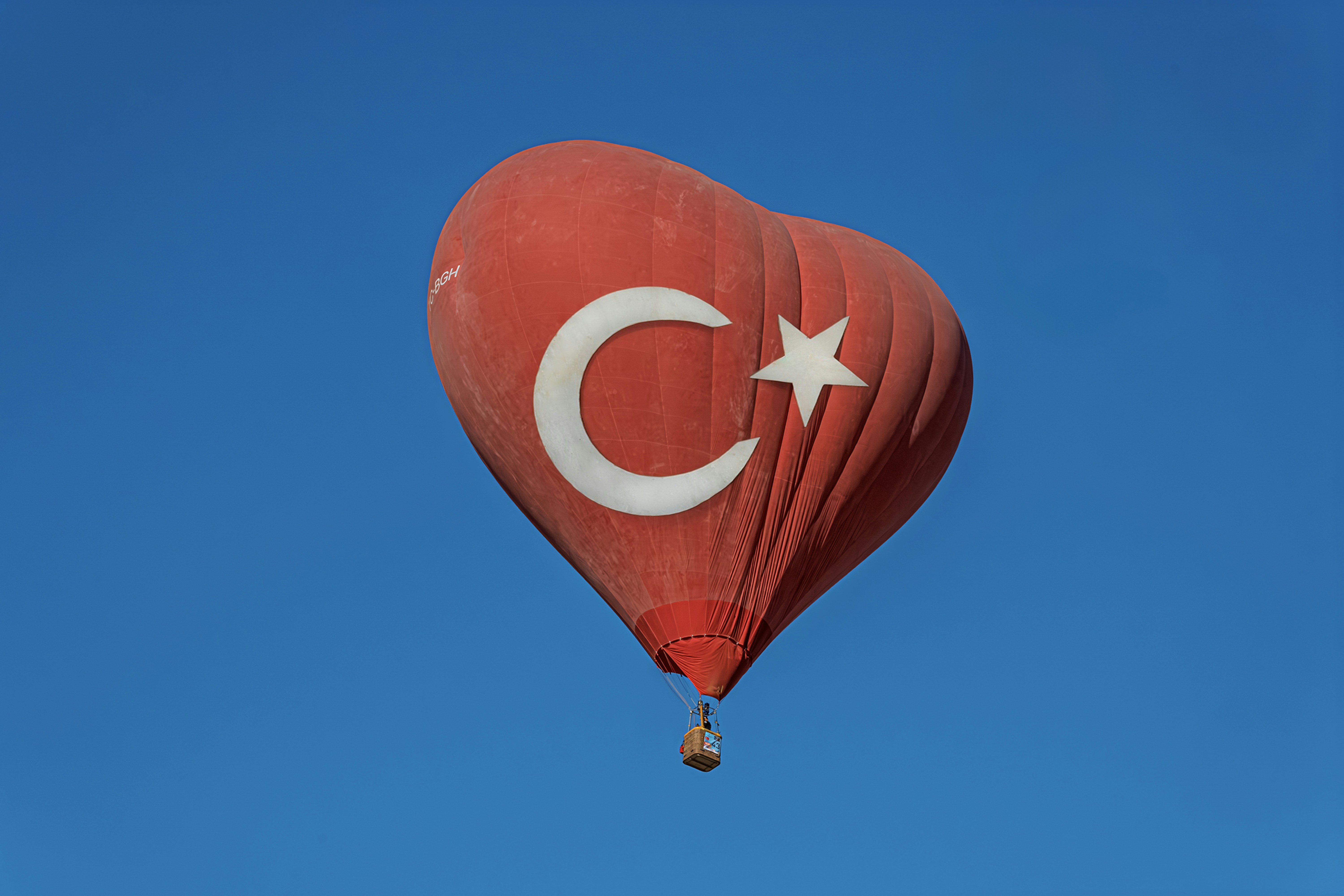 Red heart-shaped hot air balloon with turkish flag.