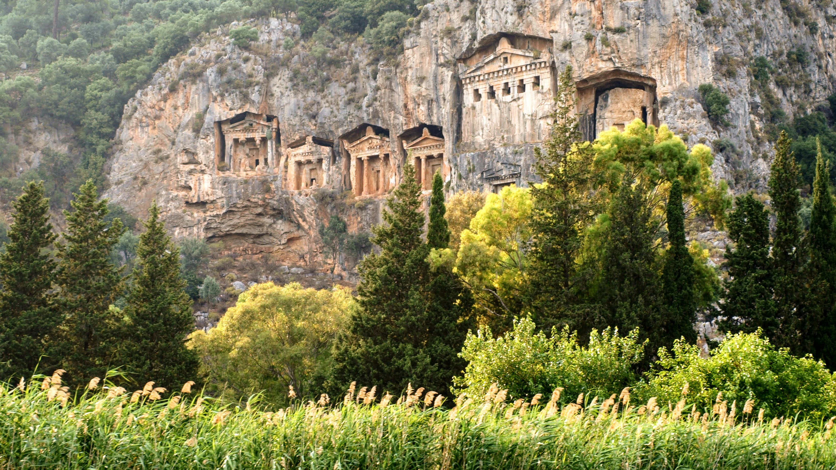 Ancient tombs carved into a rocky cliff face