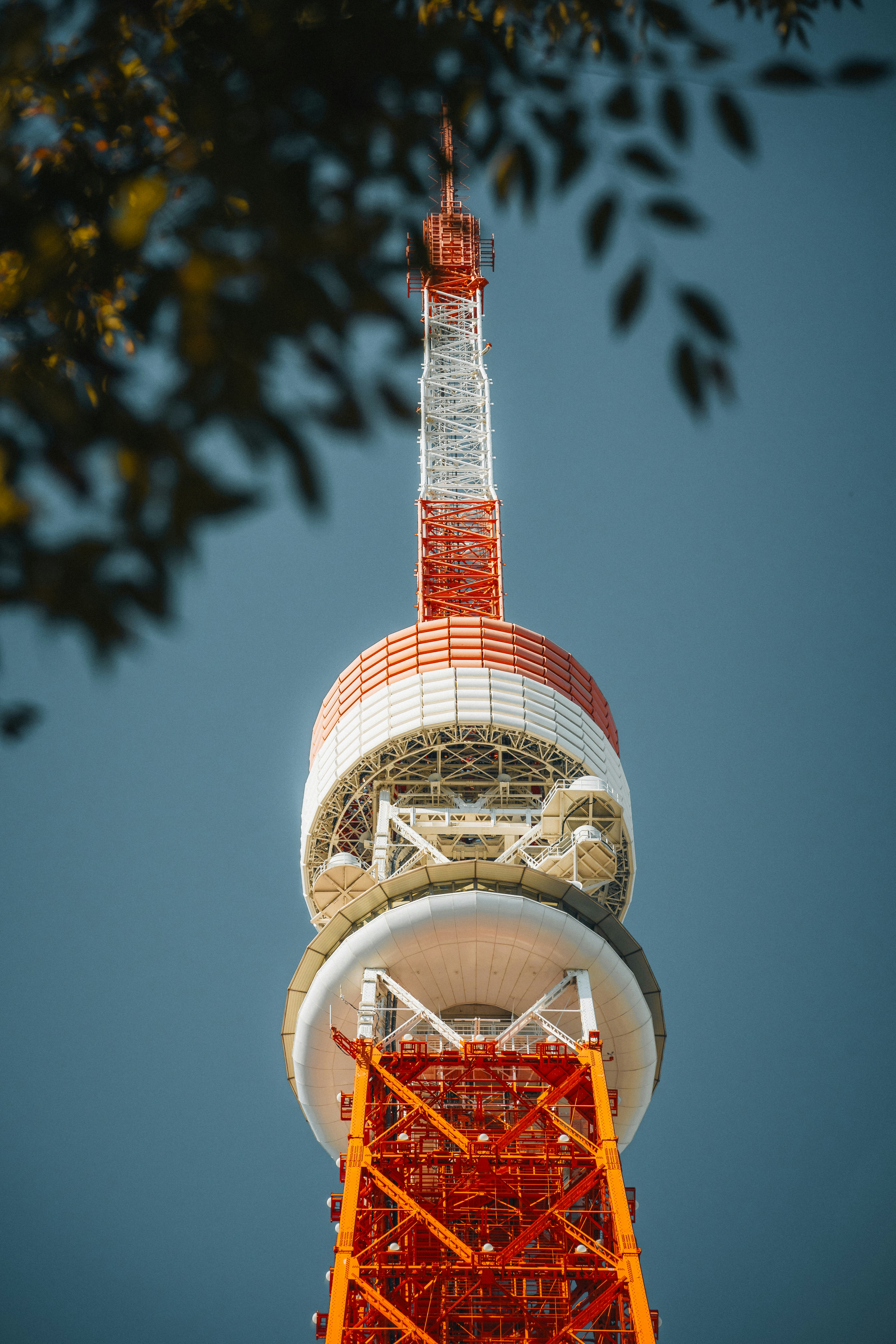 Tall red and white tower against a clear blue sky