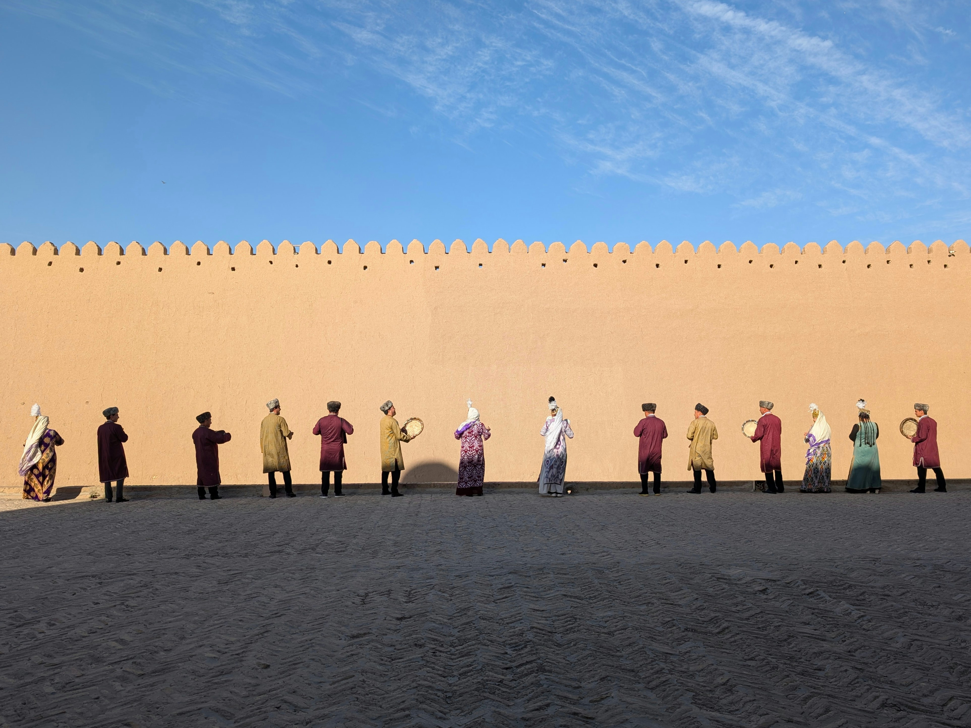 People in traditional clothing stand in a line.