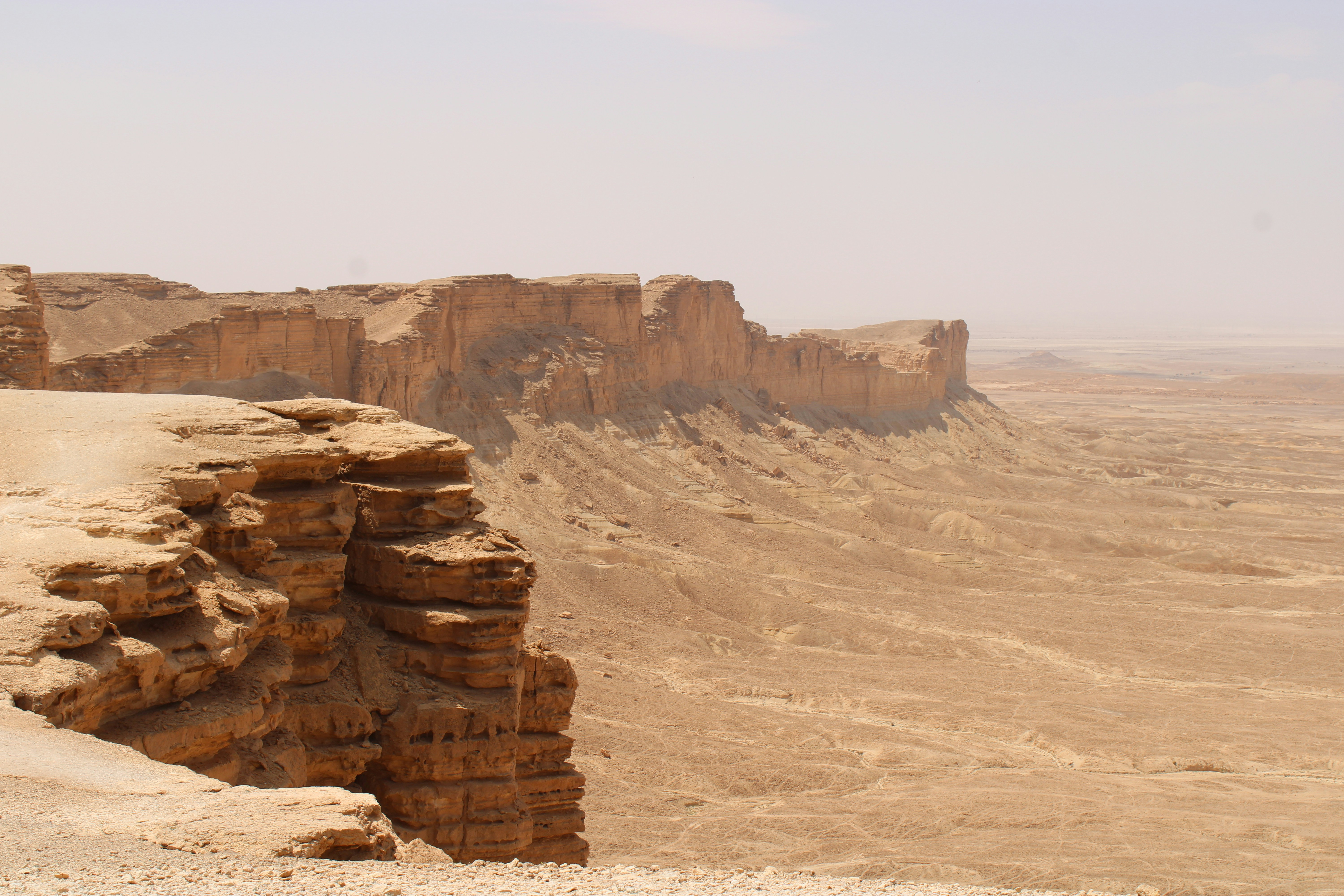 Rocky desert cliffs under a hazy sky
