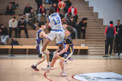 Basketball players in action during a game