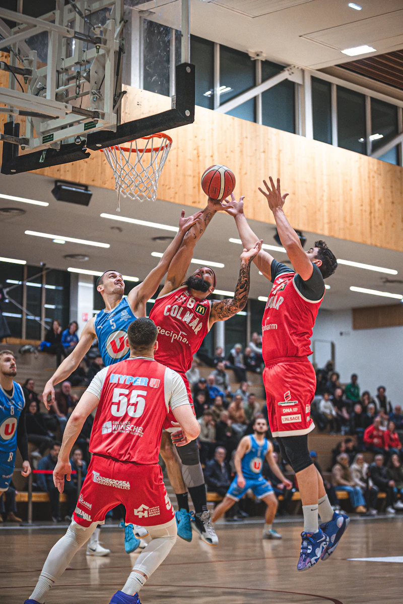 Basketball players jumping for the ball during a game