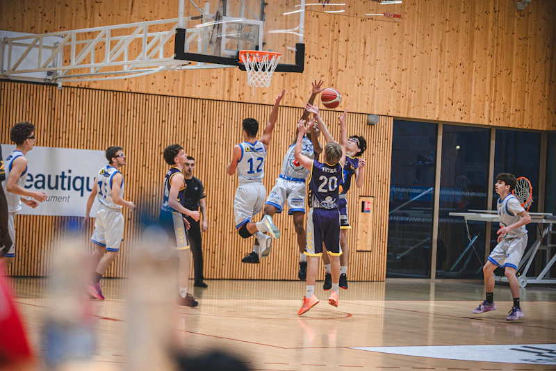 Basketball players jumping for the ball during a game