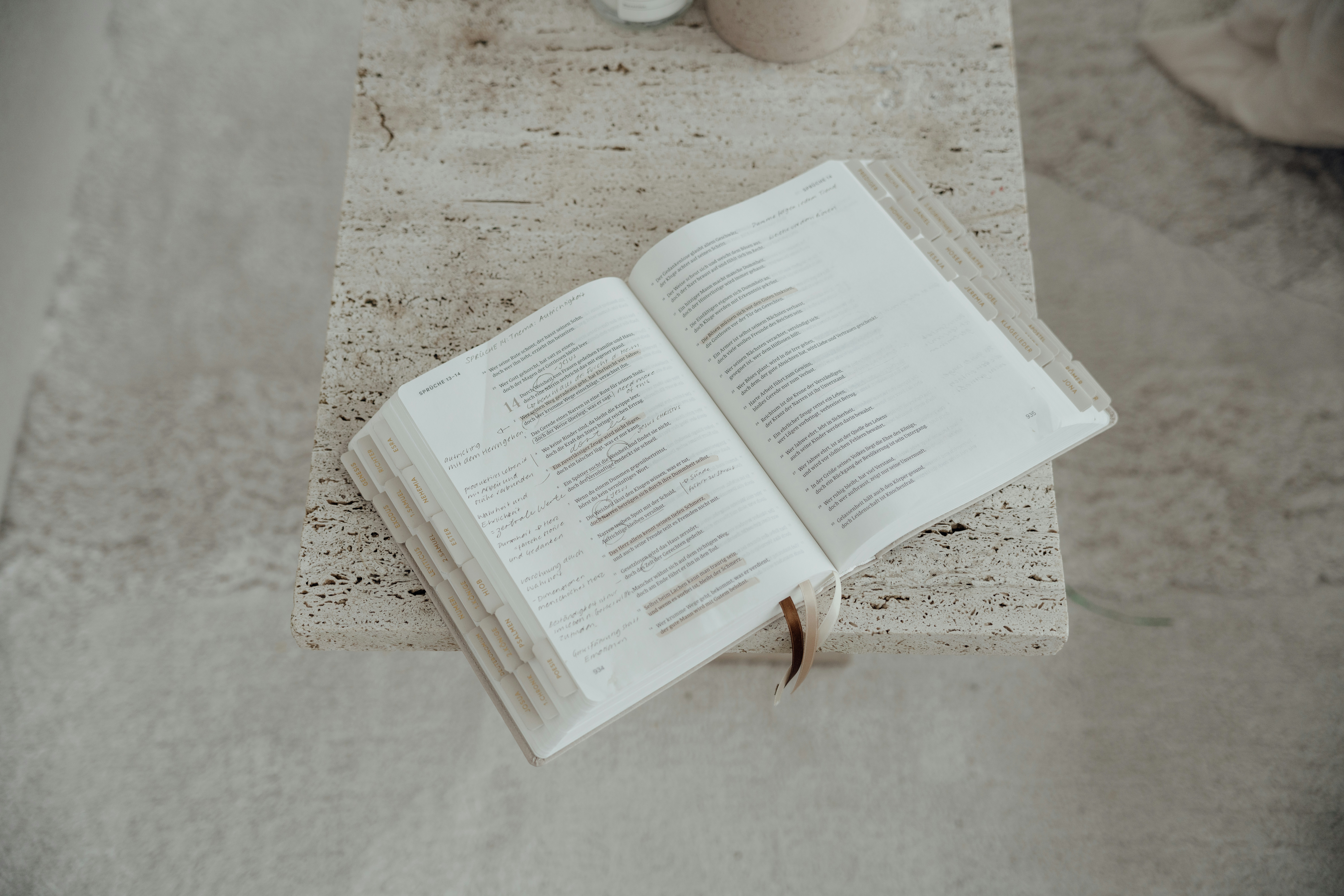 An open book with white pages on a textured surface