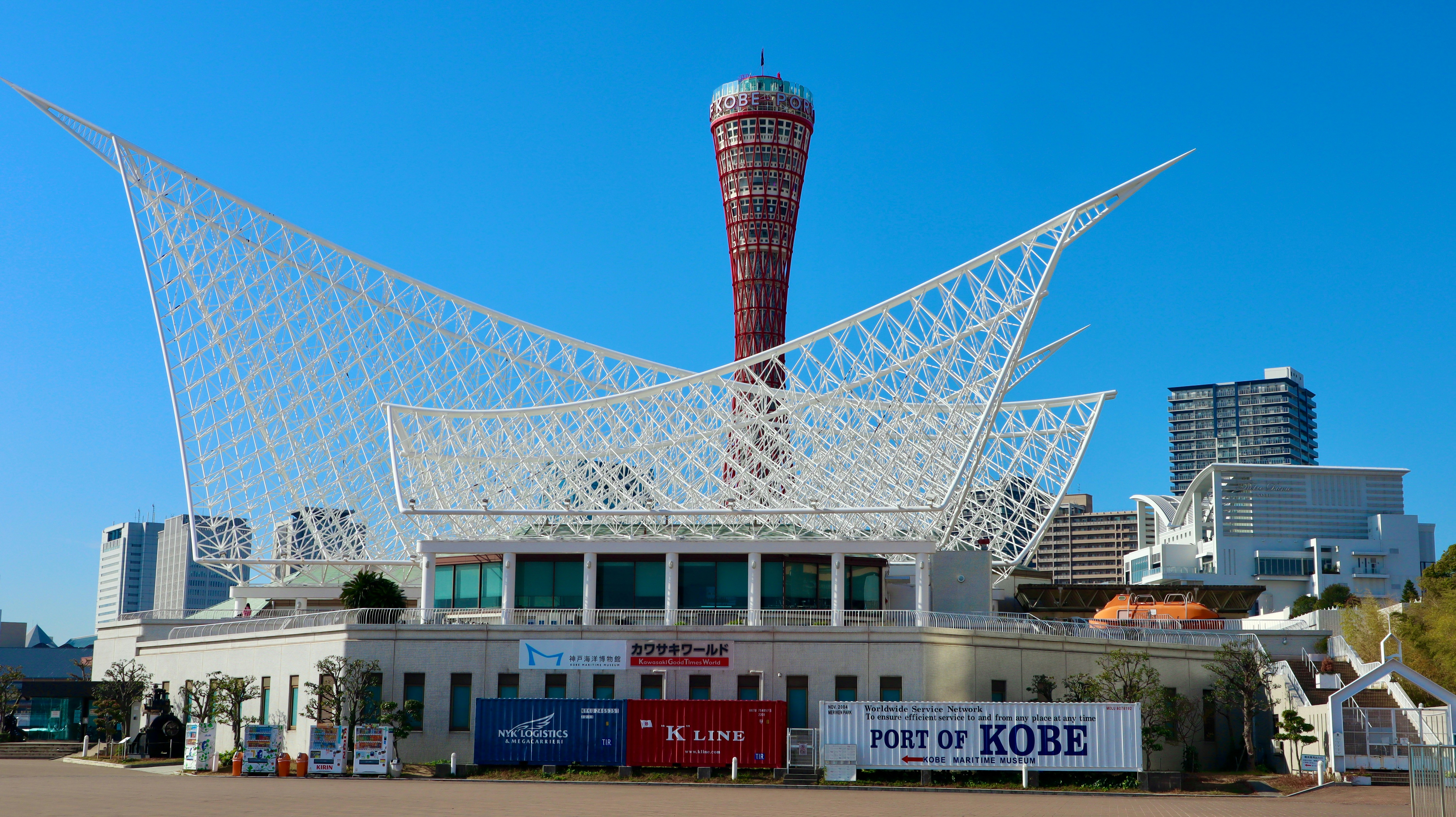 Modern white building with distinctive roof and tower