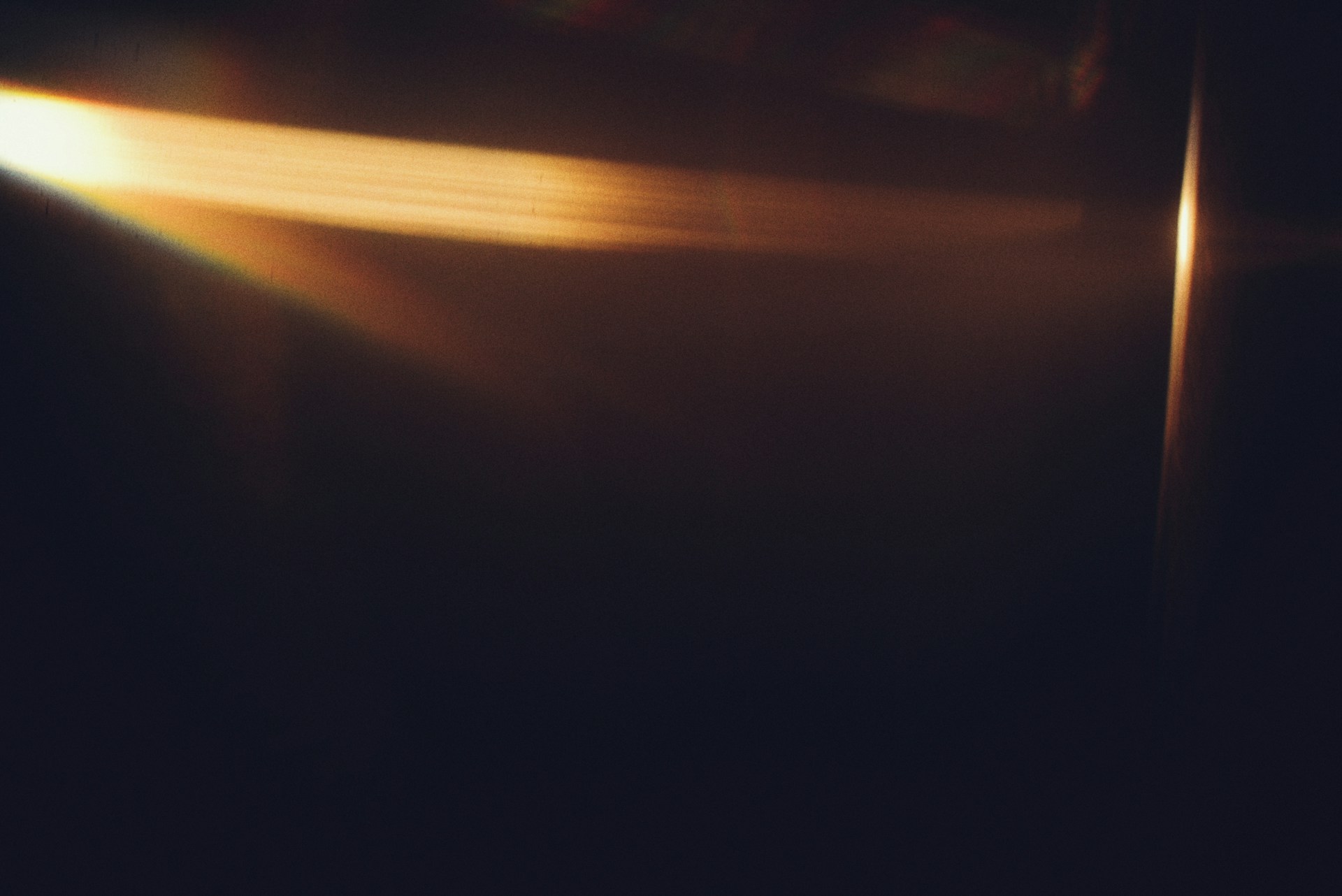 Golden light flares on a dark background