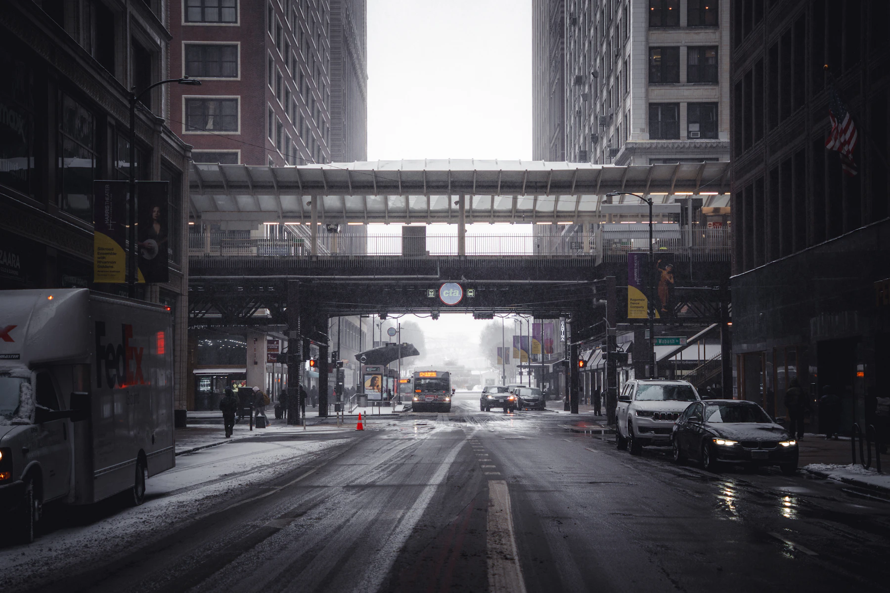 A snowy Chicago street with an elevated CTA walkway