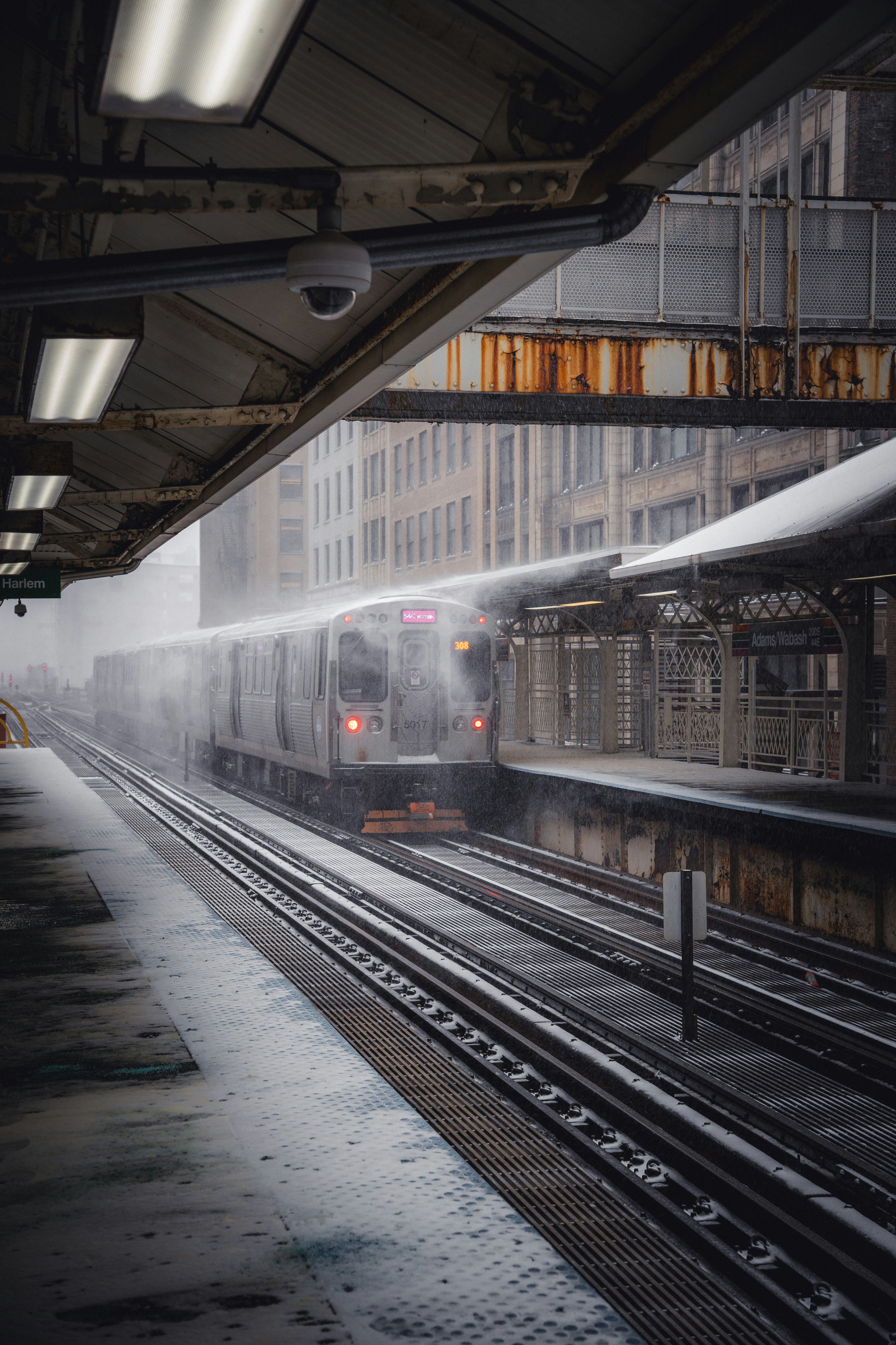 Train arriving at a snowy station platform.