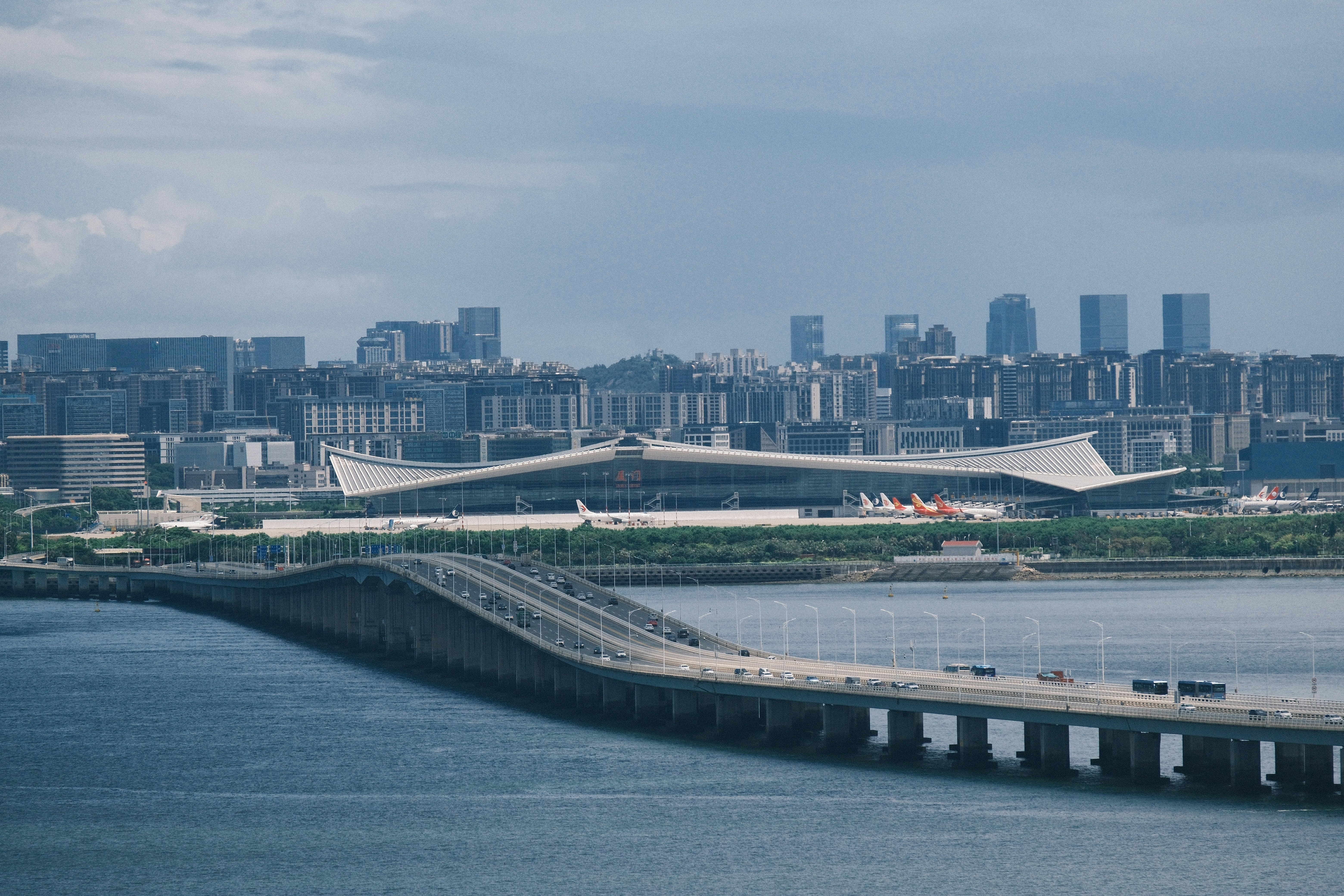 Modern airport terminal with city skyline in background